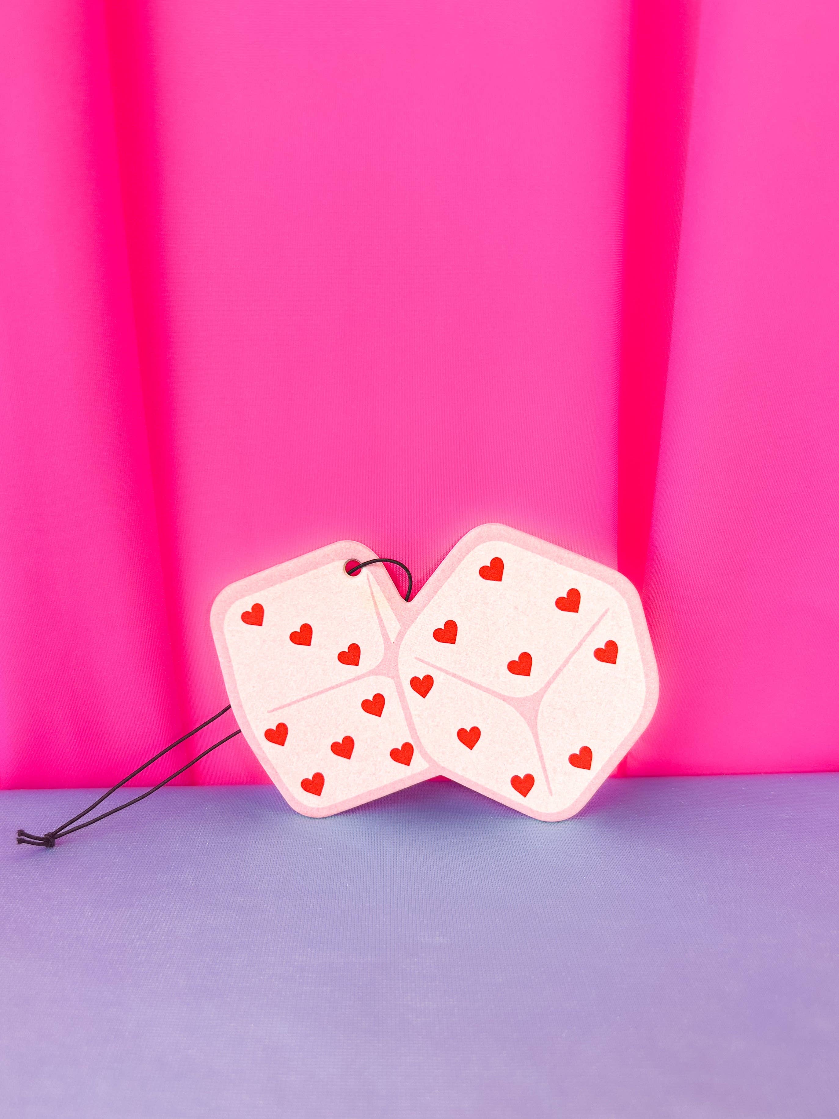 Pink Heart Dice Air Freshener with a pink background