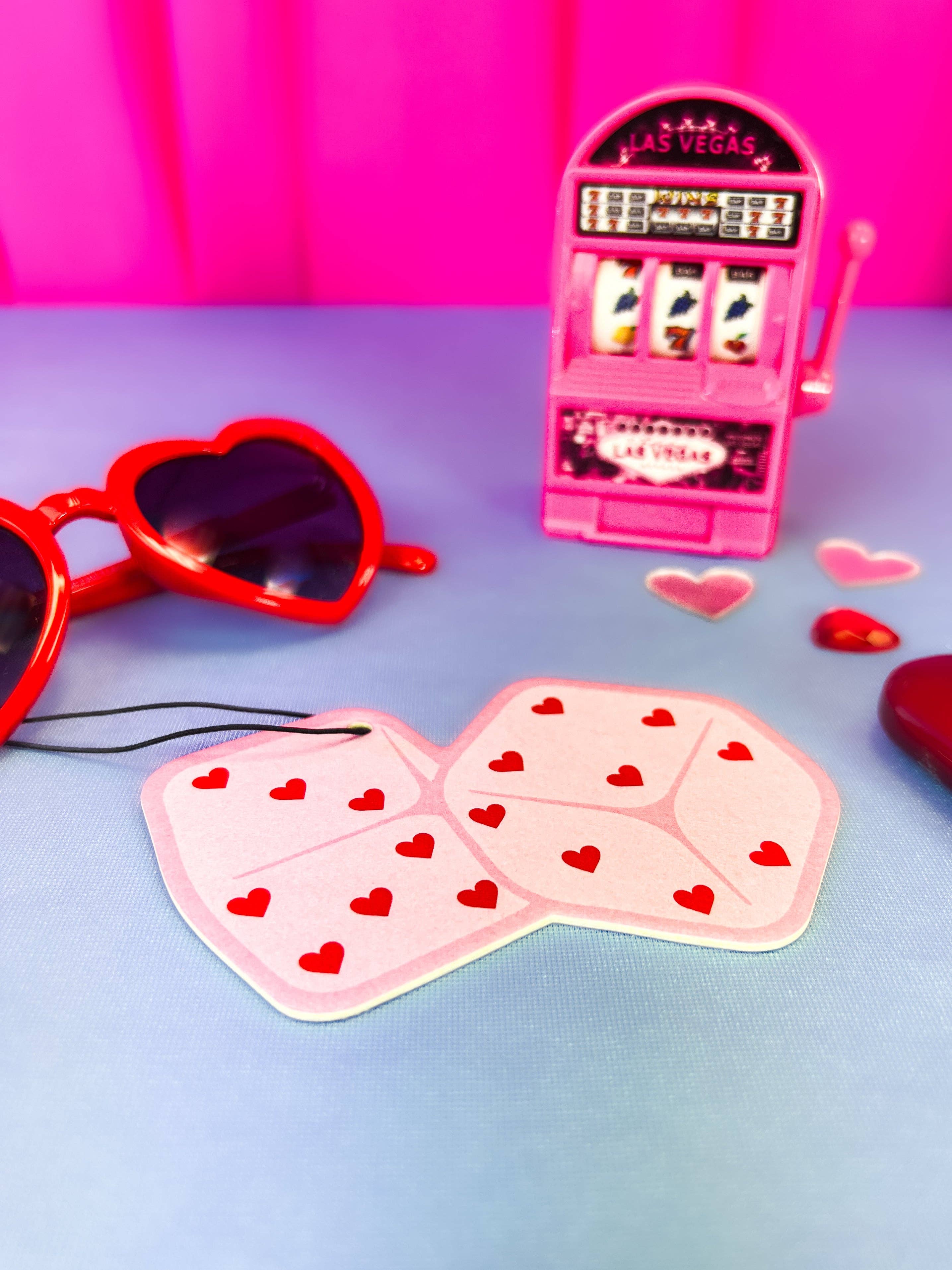 Pink Heart Dice Air Freshener with a pink background with a slot machine and red heart sunglasses