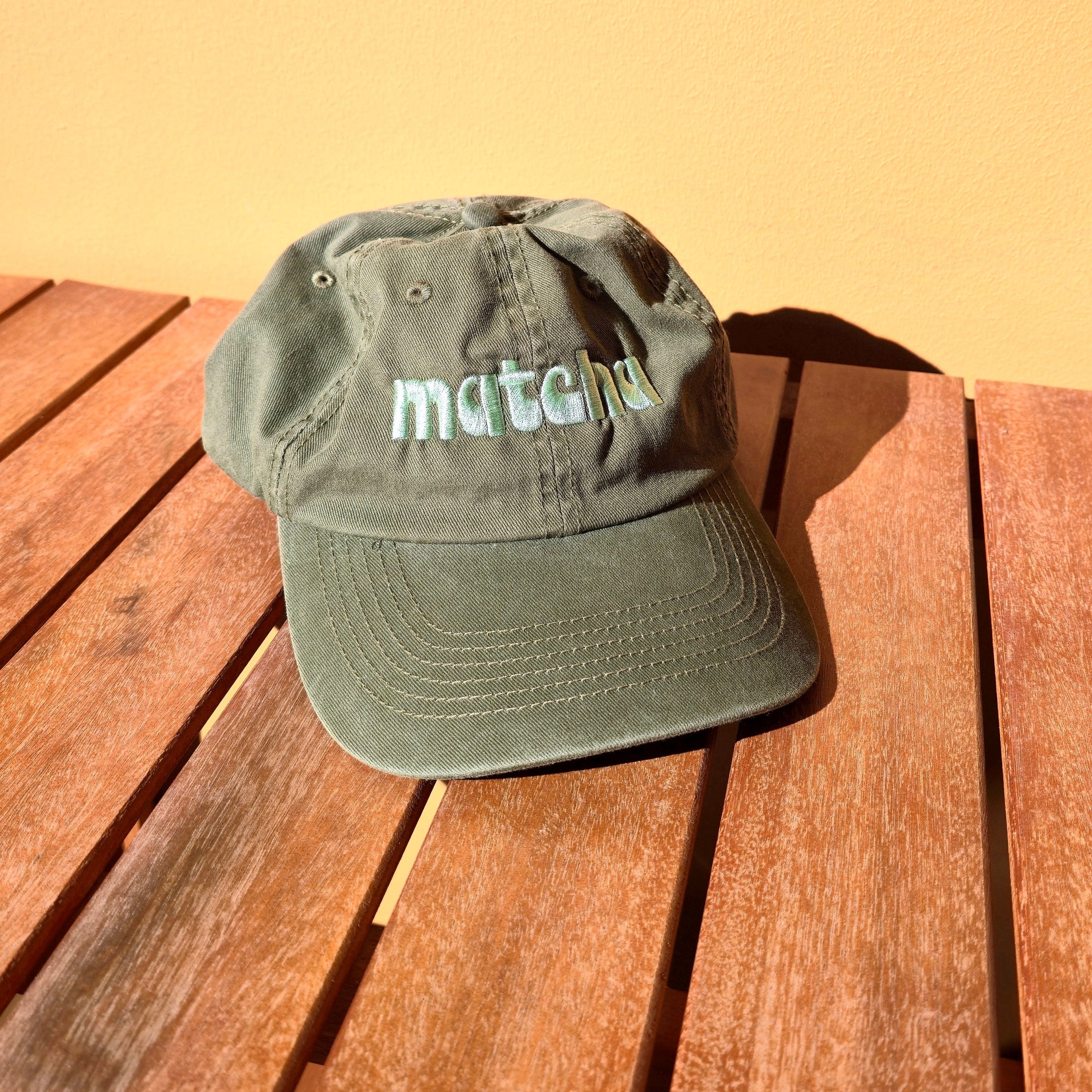 Green cap with text on a wooden surface