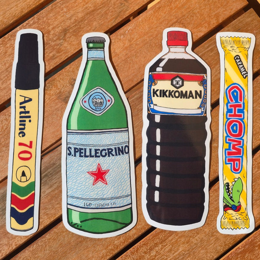Four product packaging magnets illustrations on a wooden surface