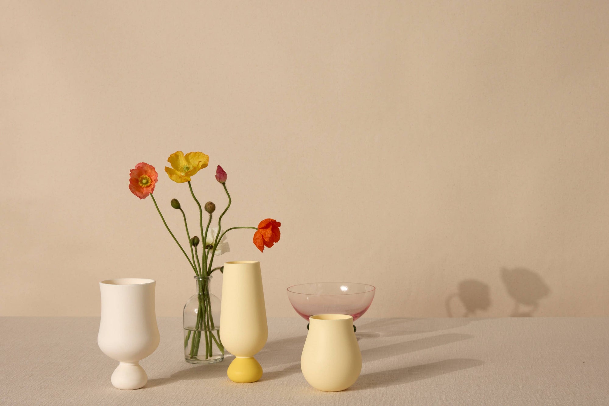 Set of colorful silicone cups on a neutral background