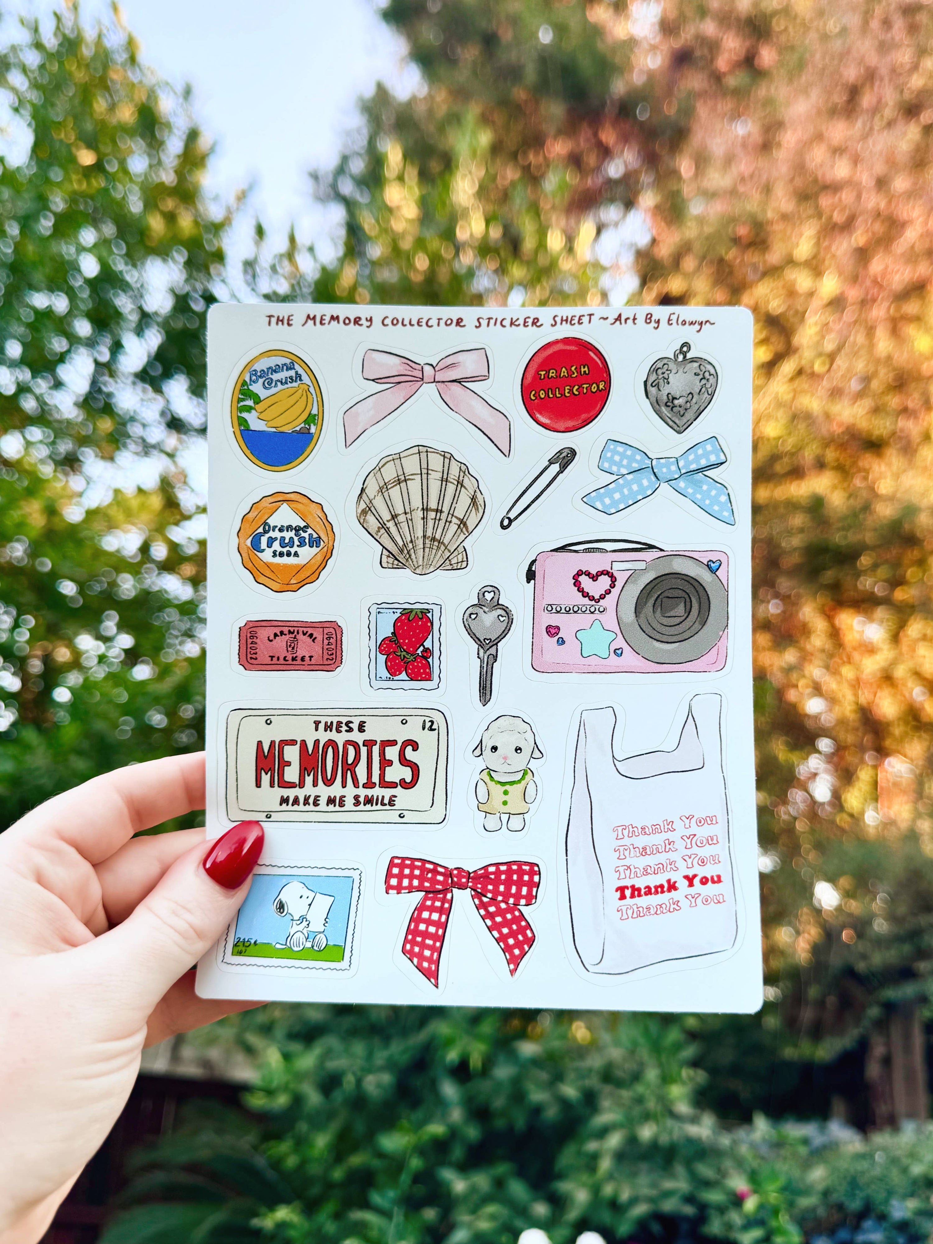 Sheet of stickers held by a hand with a blurred natural background