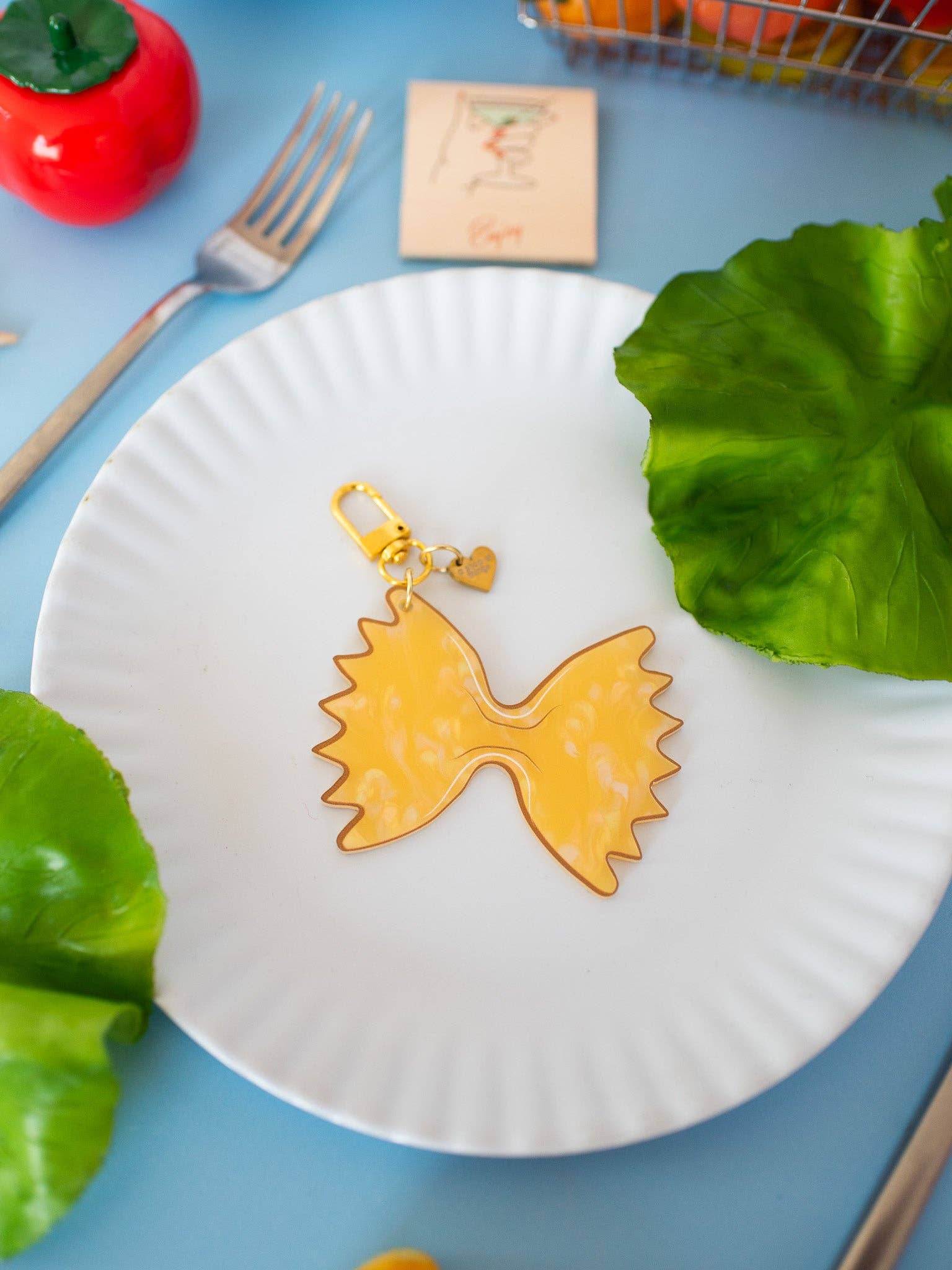 Farfalle Pasta Keychain white plate and blue table