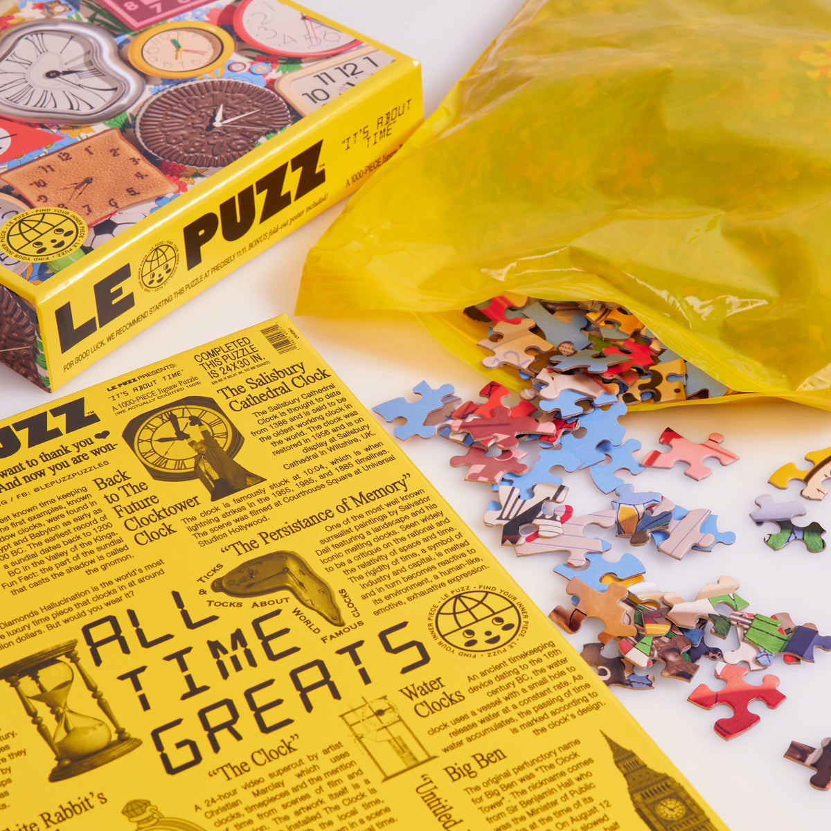 It’s About Time puzzle box and “All Time Greats” insert beside loose pieces spilling from a yellow bag.