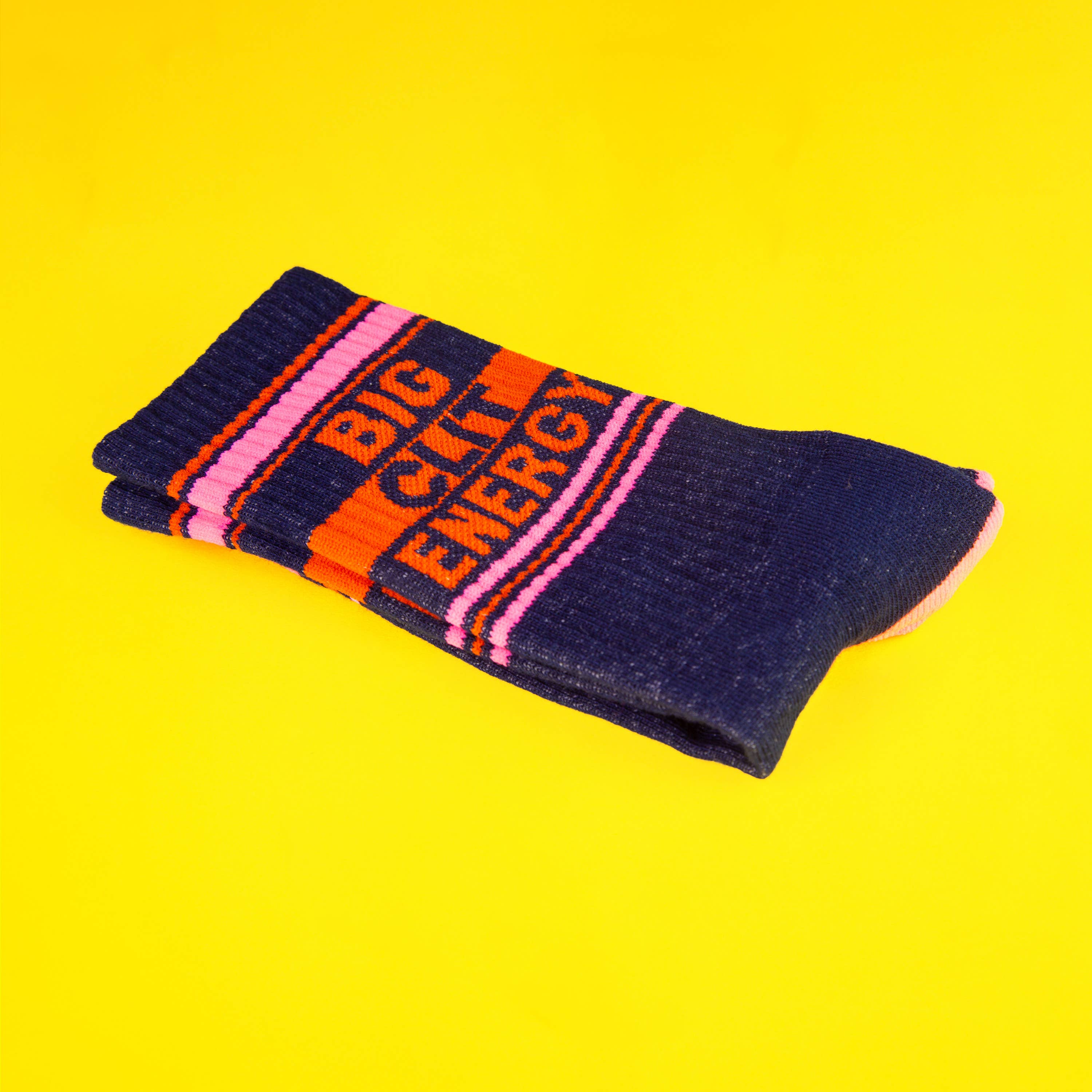 Pair of socks with 'Big City Energy' text on a yellow background