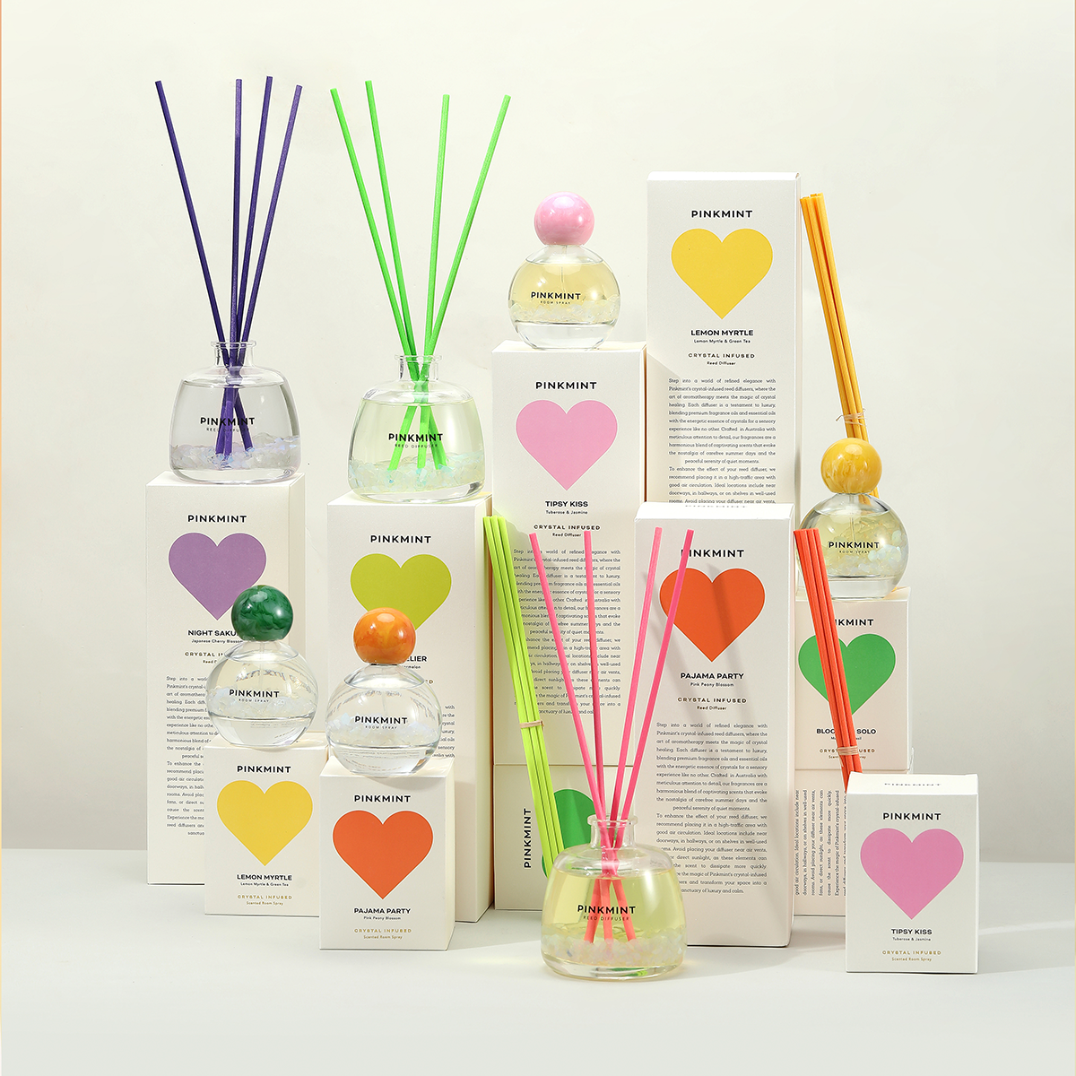 Collection of diffusers with colorful heart-shaped labels on a white background