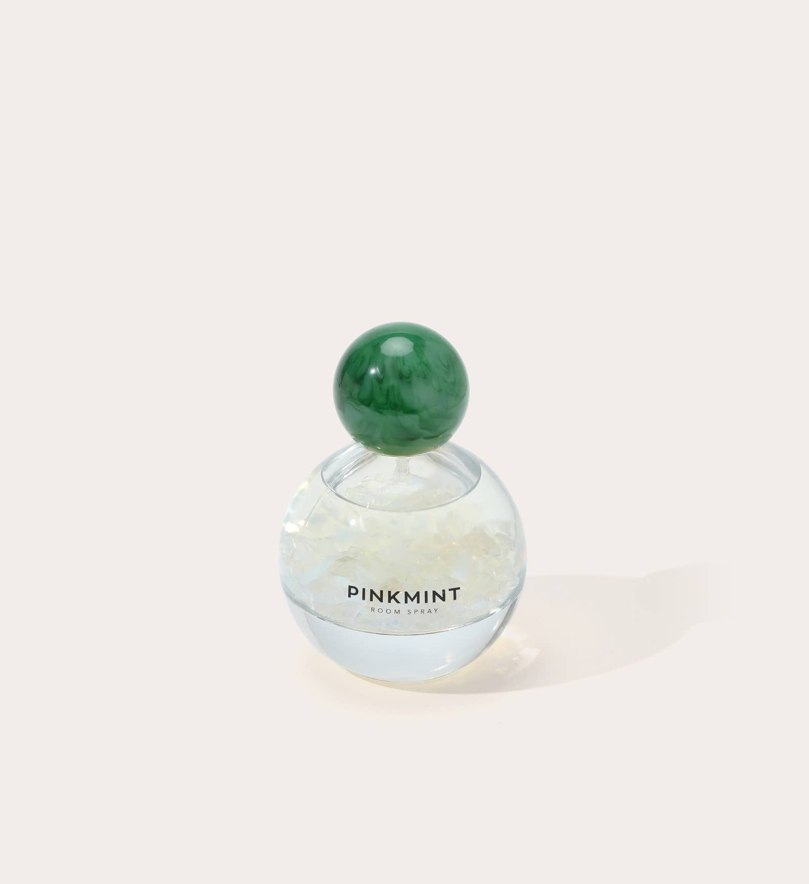 Perfume bottle with green cap on a white background