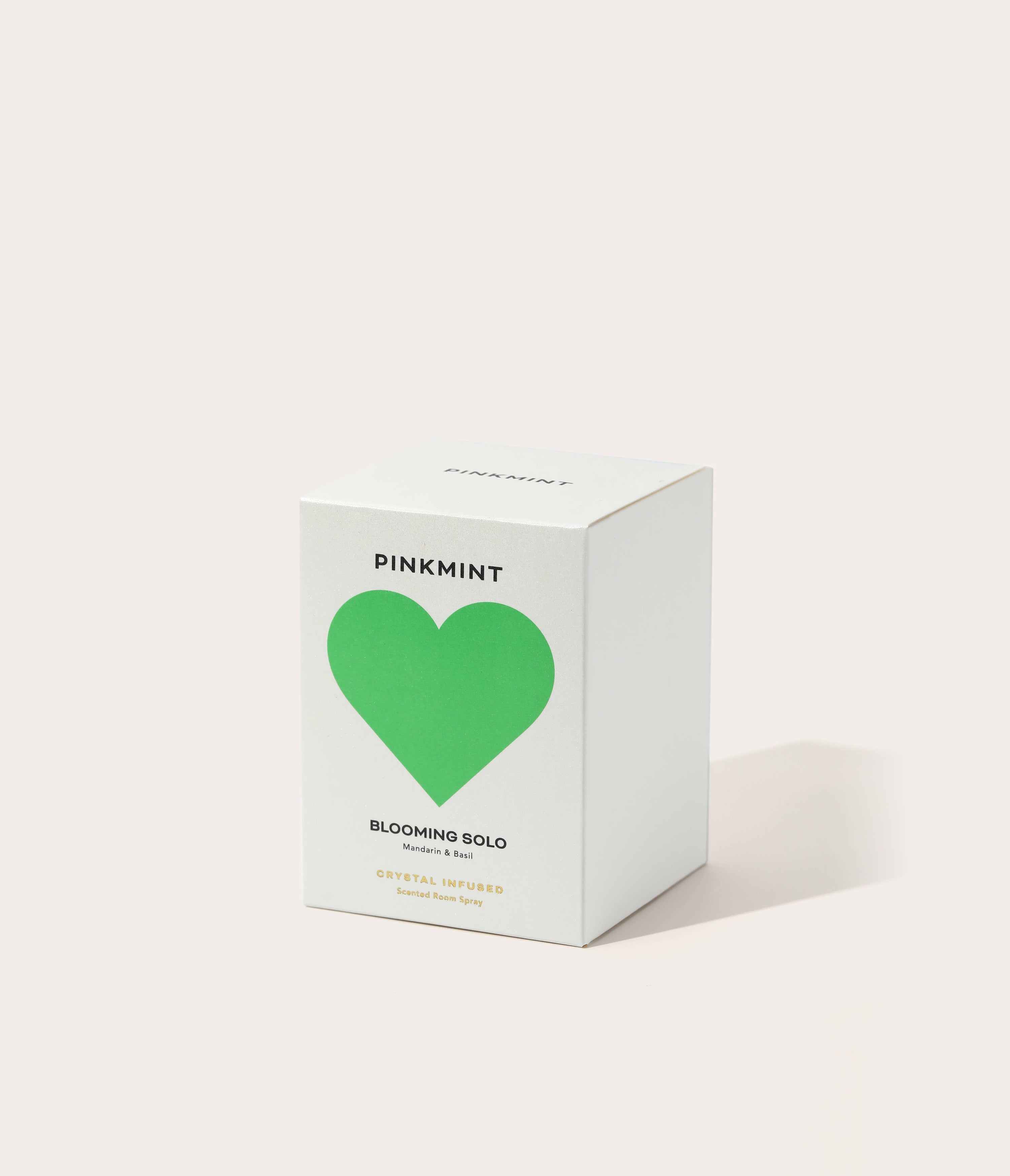Pinkmint candle packaging with a green heart on a white background