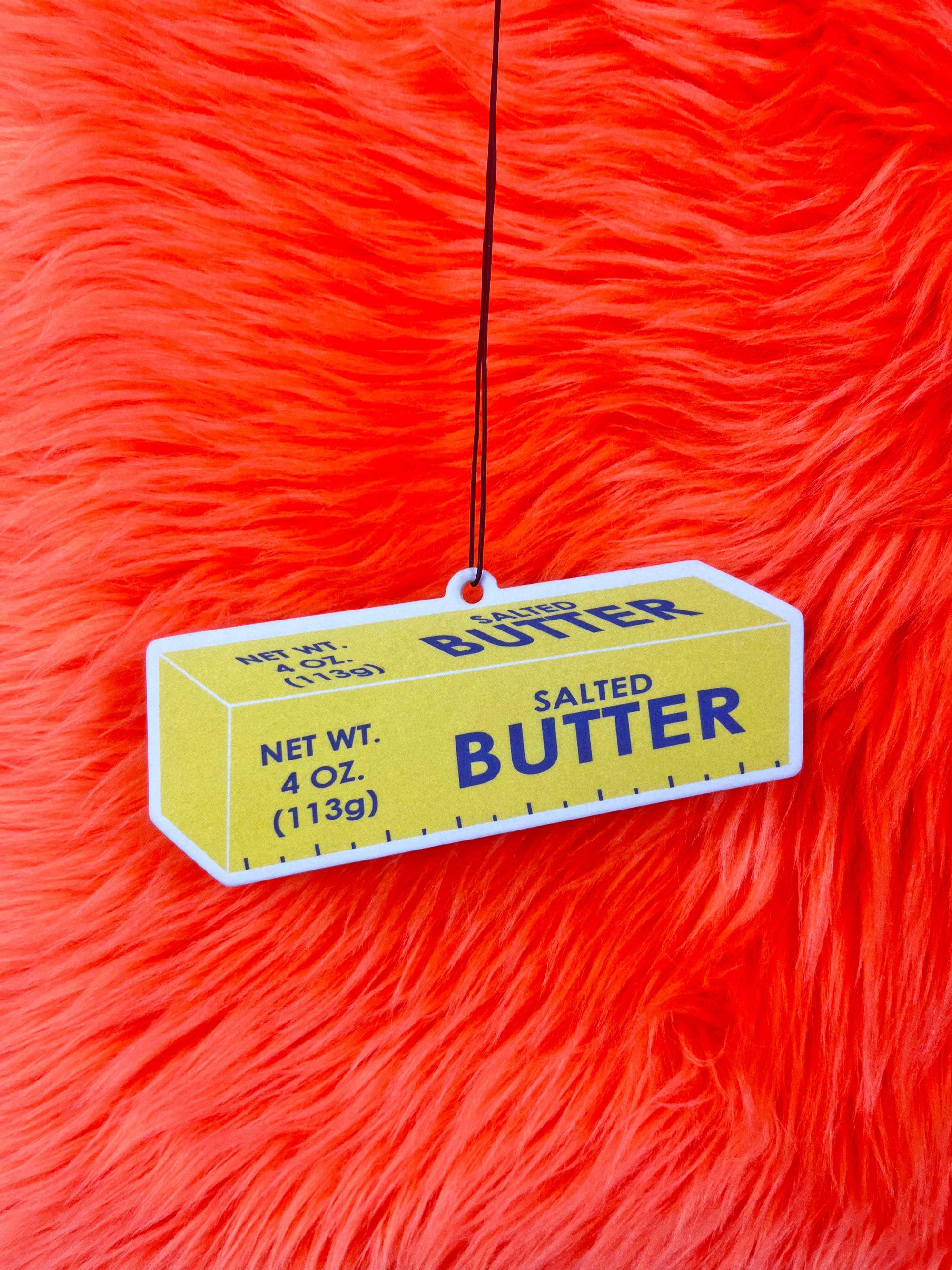 Butter Air Freshener with red background