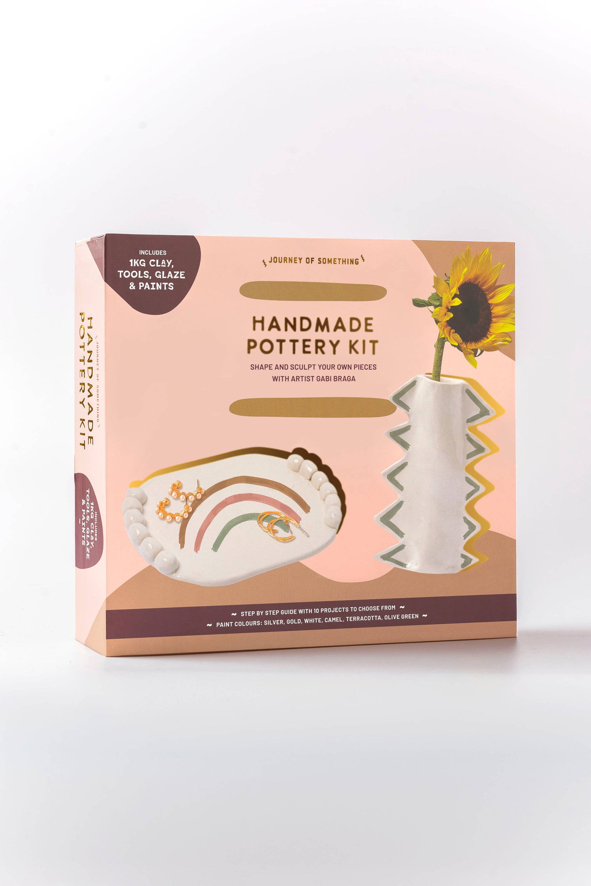 Handmade pottery kit packaging with a sunflower design on a white background