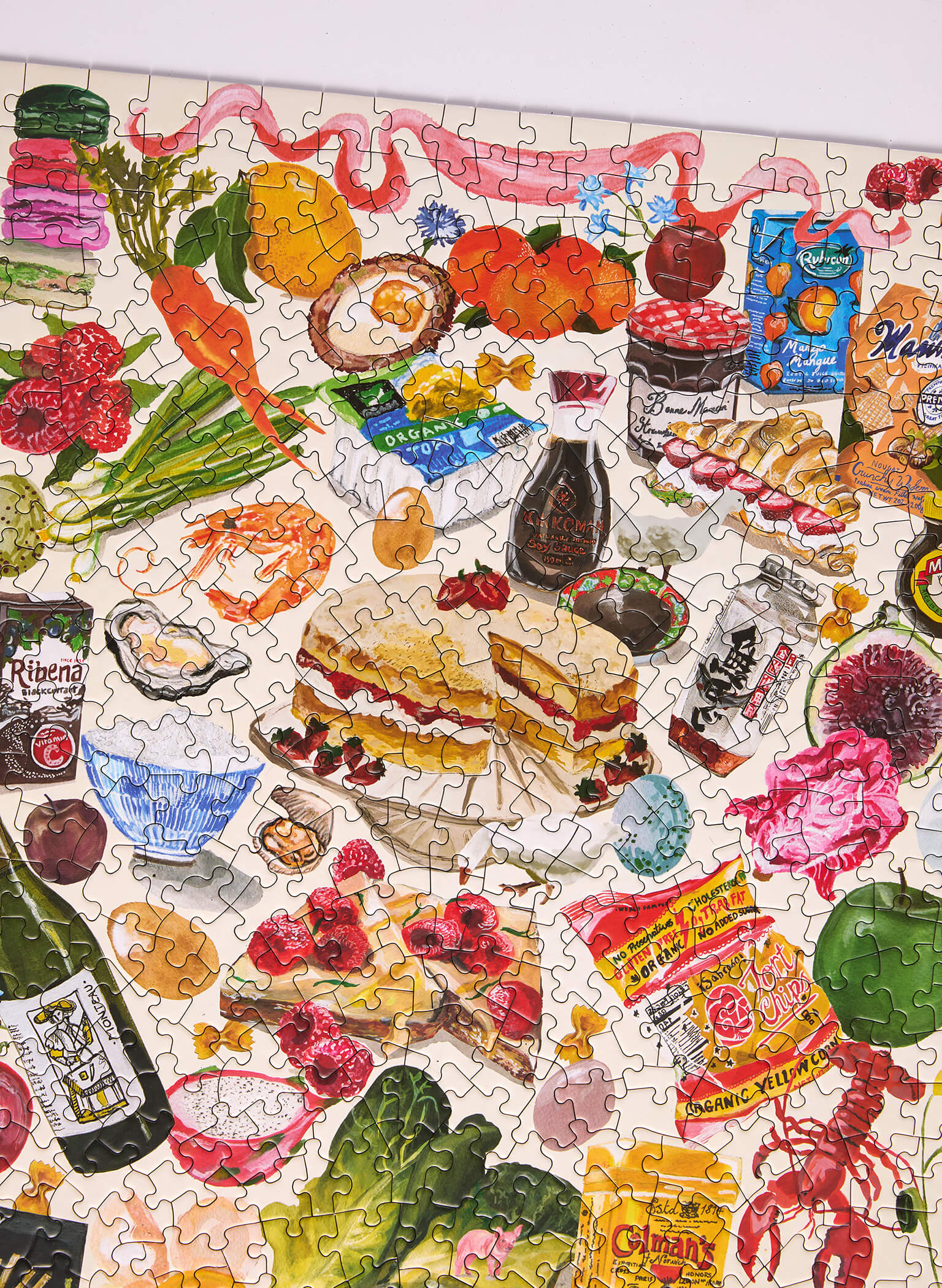 Partial puzzle with various food items and packaging on a white background