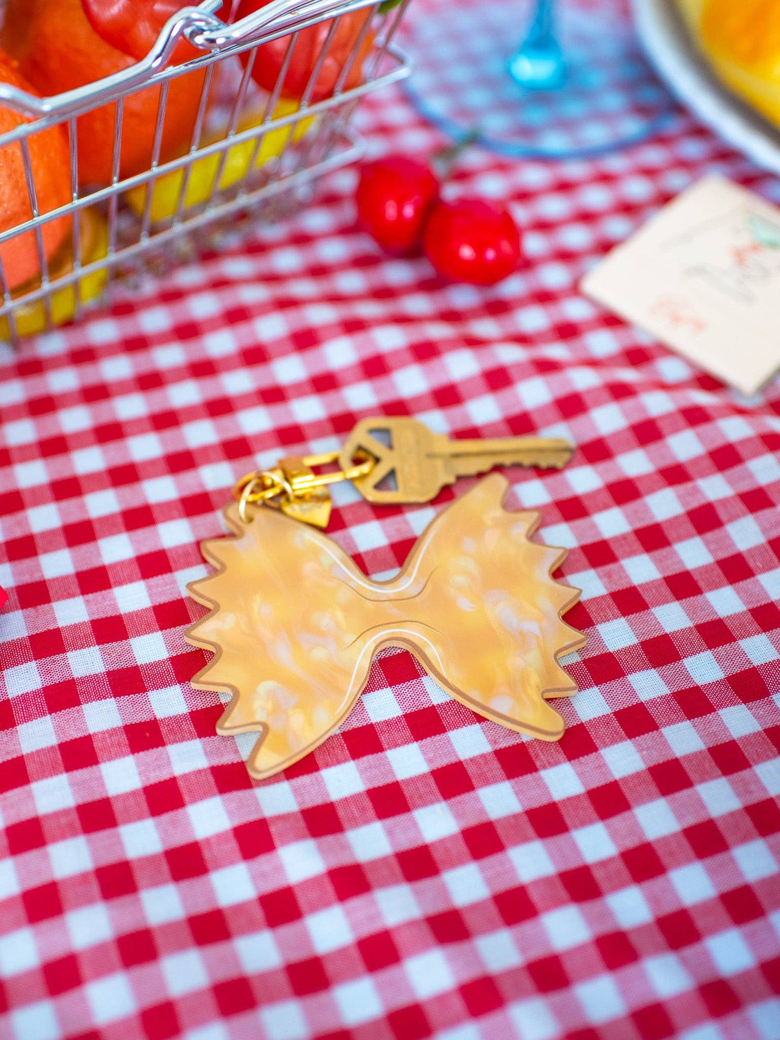 Farfalle Pasta Keychain with key and red and white tablecloth