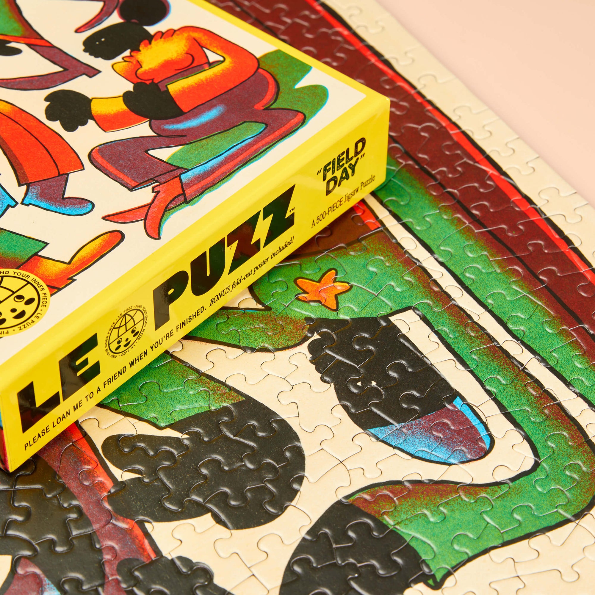 Colorful puzzle with a box labeled 'LE PUZZ' on a partially completed puzzle.