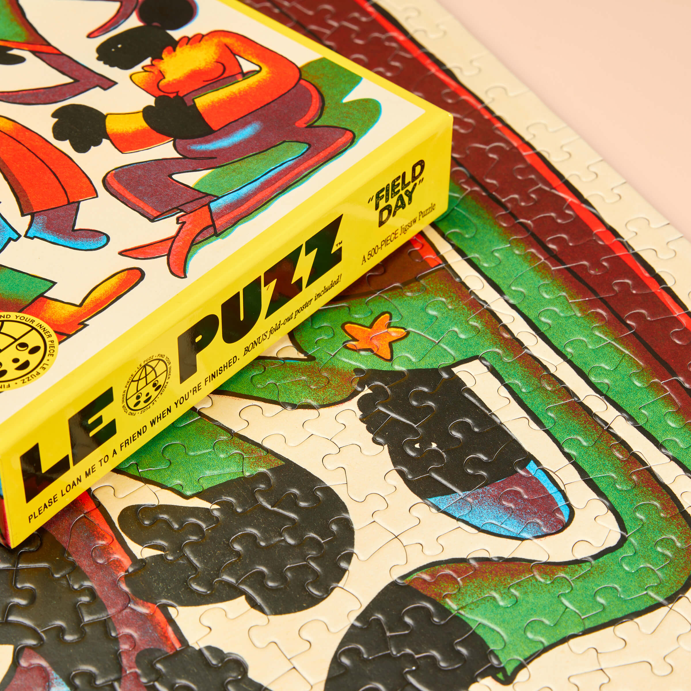 Colorful puzzle with a box labeled 'LE PUZZ' on a partially completed puzzle.