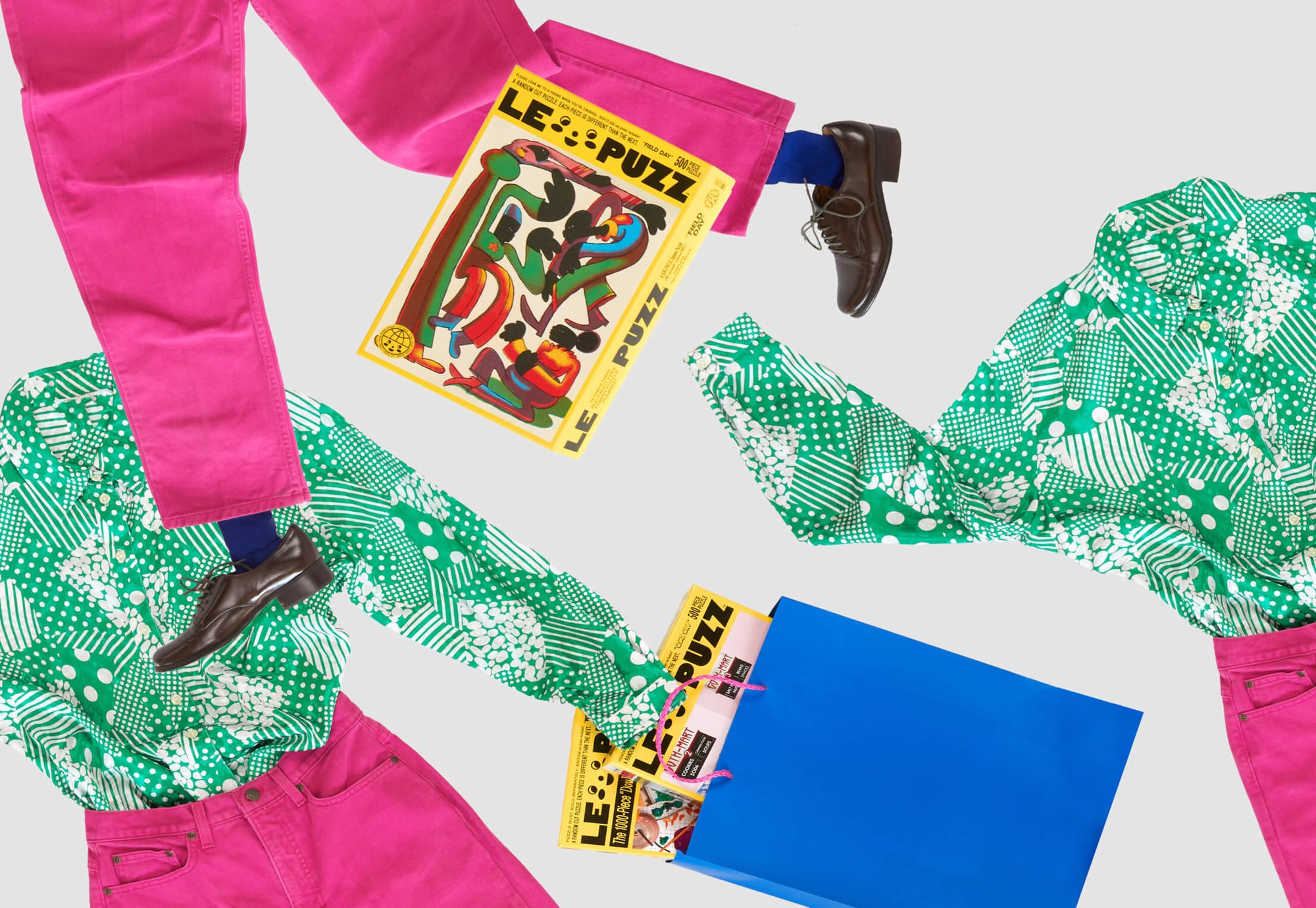 Colorful clothing with a puzzle book and blue paper on a white background