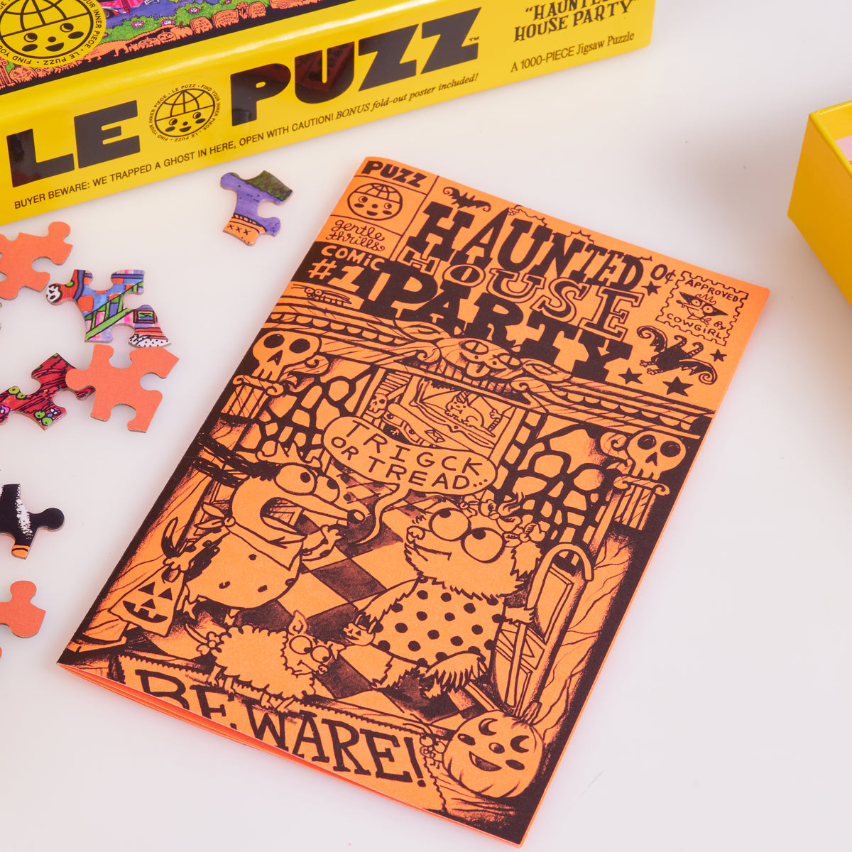 Orange Haunted House Party comic booklet beside loose puzzle pieces and the yellow Le Puzz box.