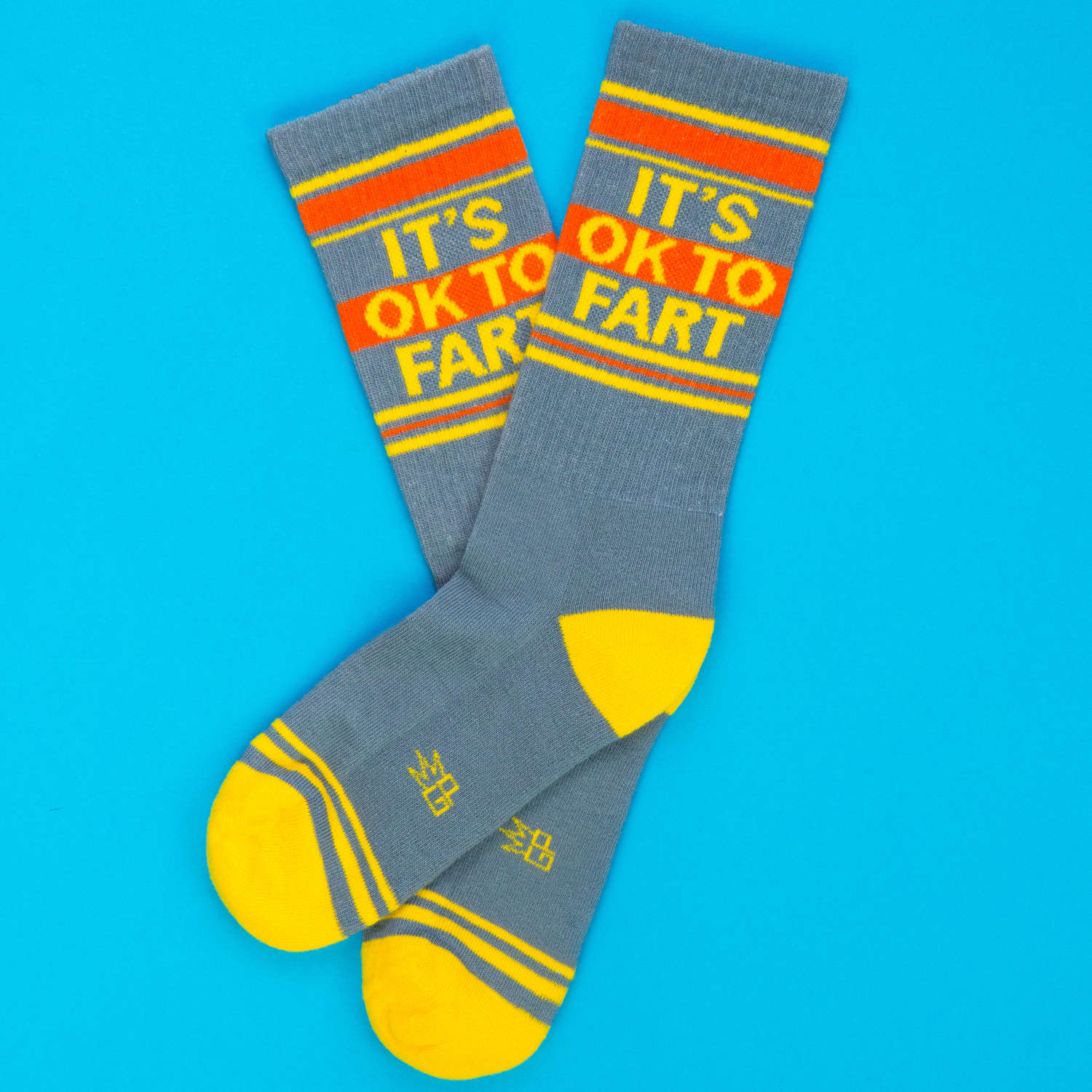 Gray socks with colorful text on a blue background
