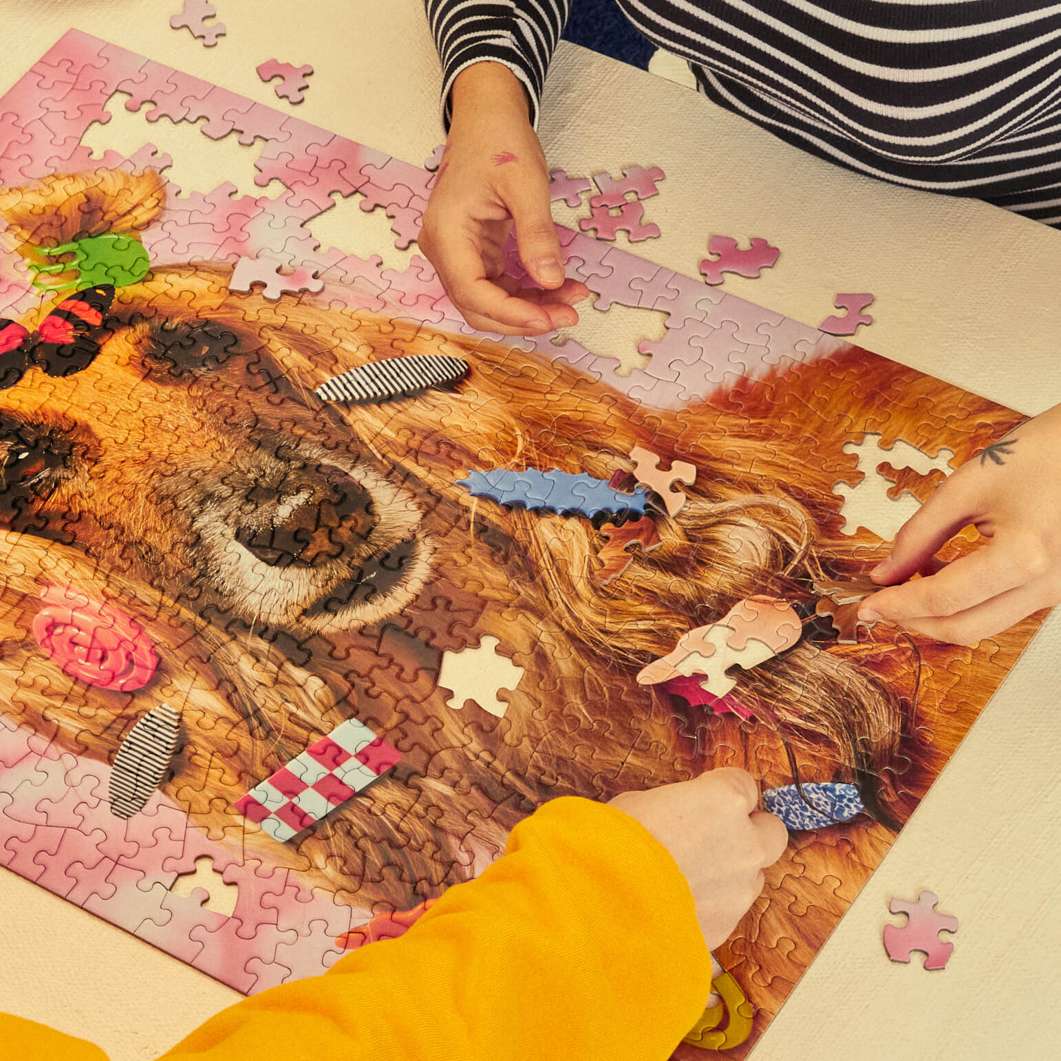 People working on a puzzle of a dog with accessories