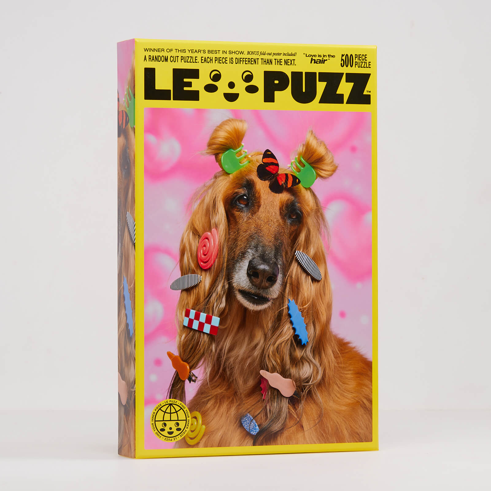 Jigsaw puzzle box featuring a dog with decorative hair accessories on a pink background