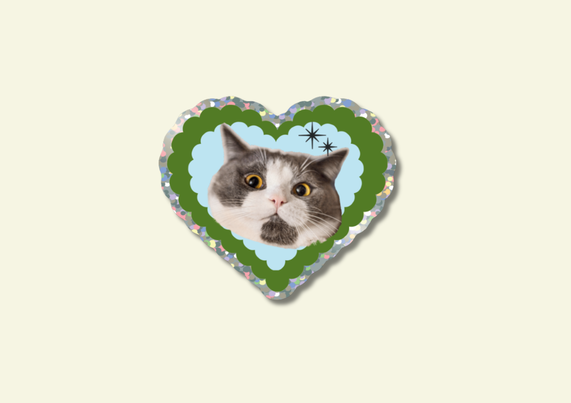 Heart-shaped sticker with a cat's face on a beige background