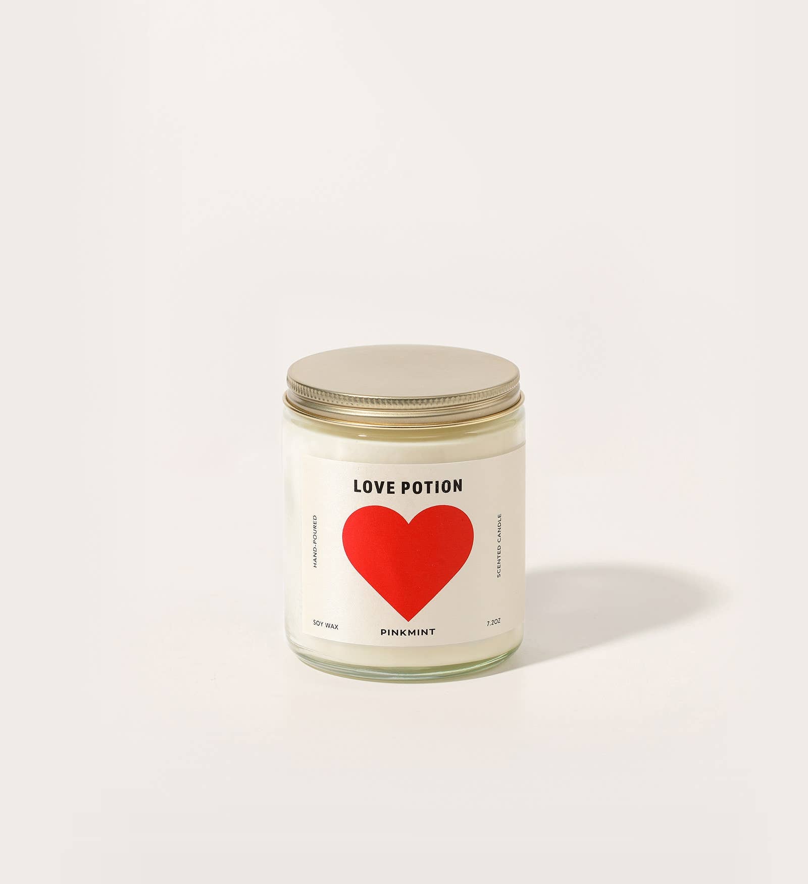 Candle jar with a red heart label on a white background