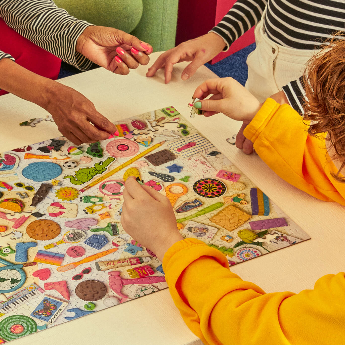 Children playing with a colorful activity book on a table.