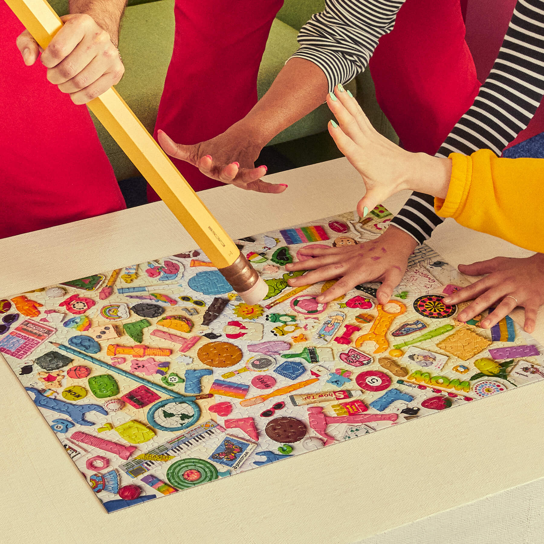 Colorful board game being played with hands on a table