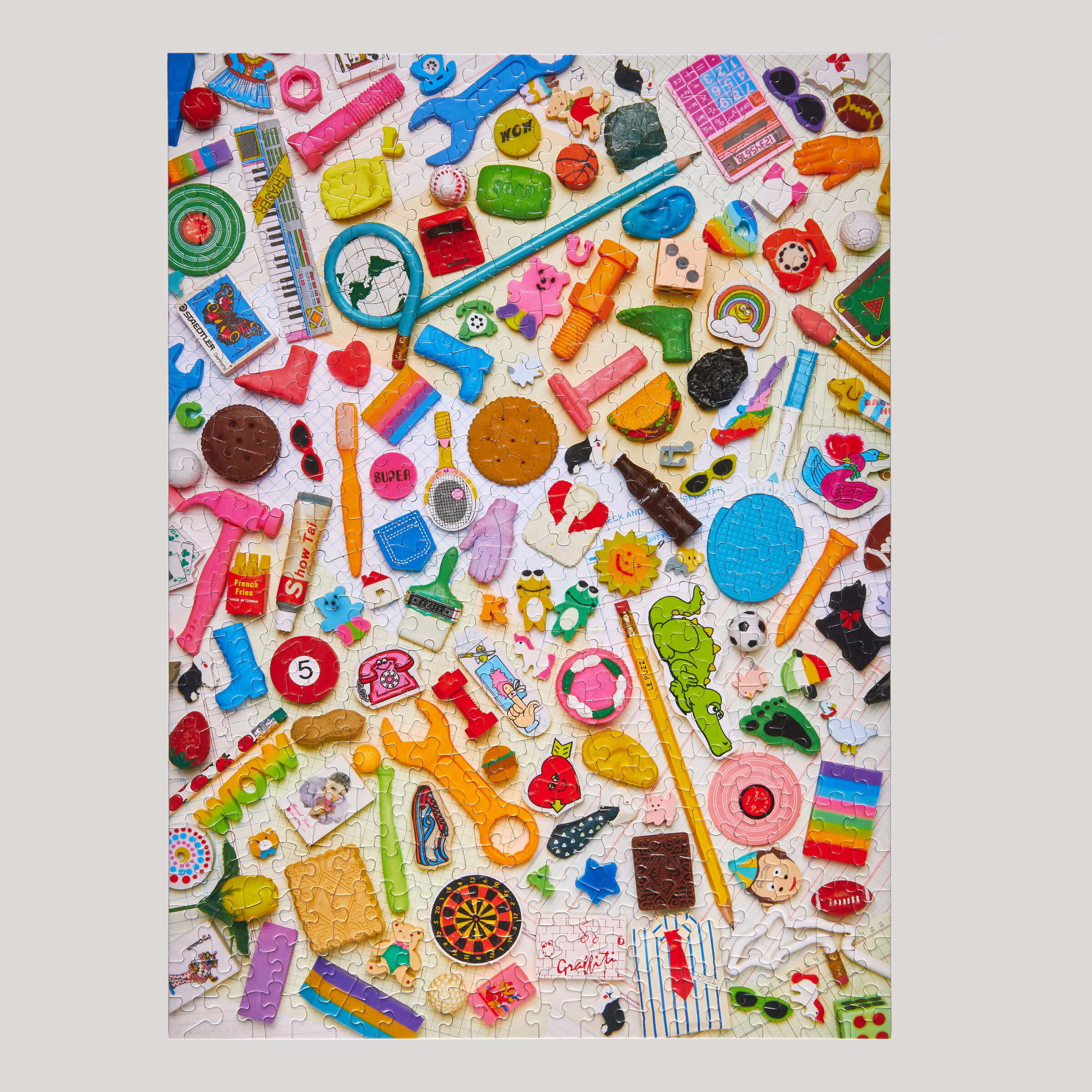 Colorful assortment of small toys and items on a white background