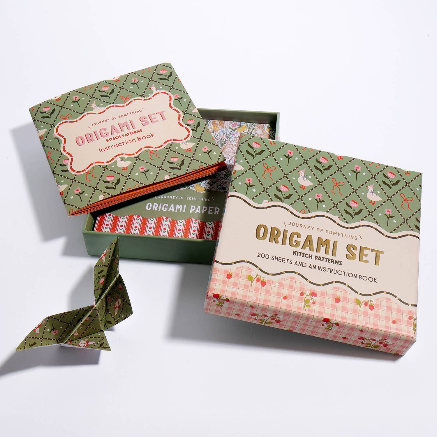 Origami set with paper and instructions on a white background