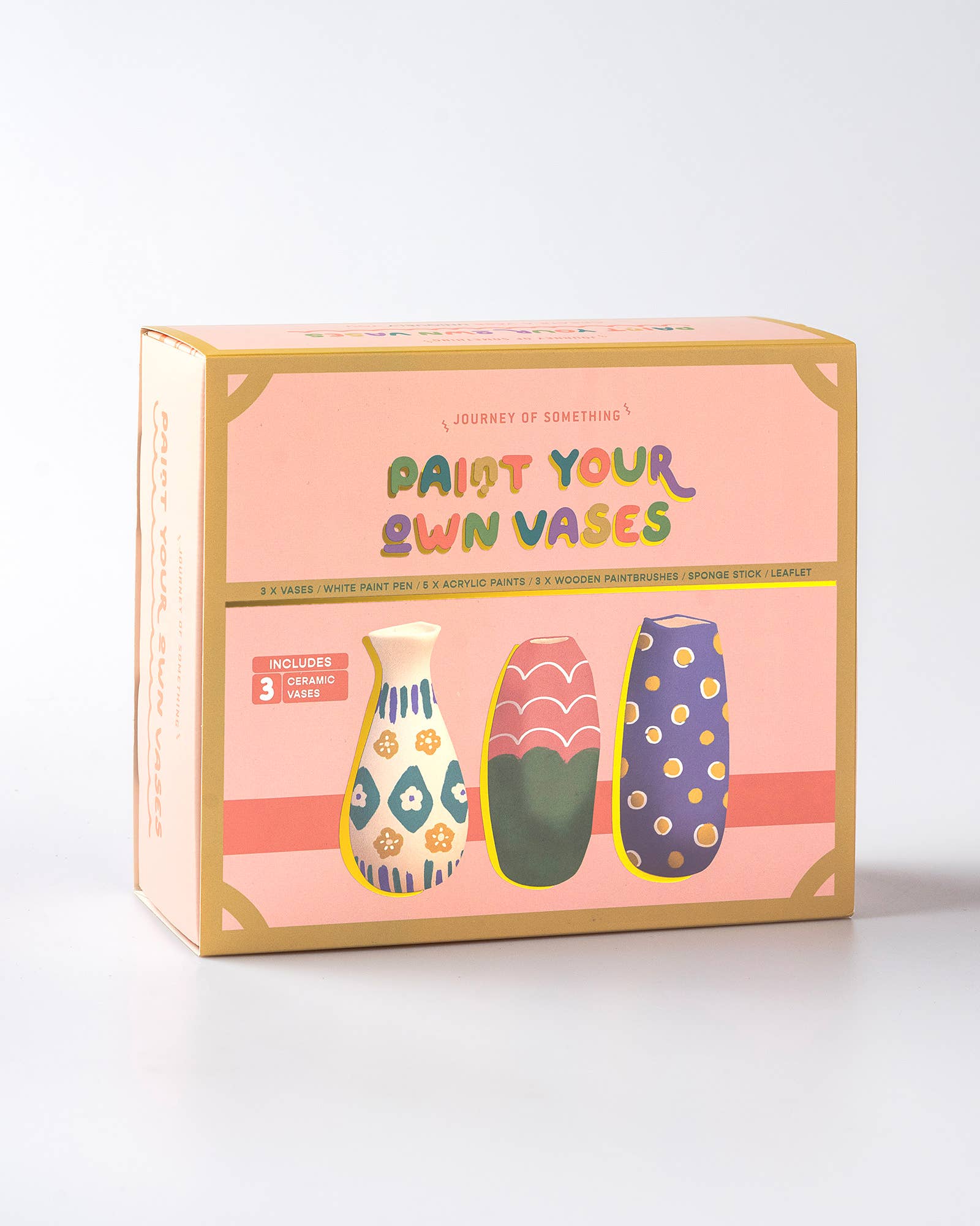 Box of 'Paint Your Own Vases' craft kit with colorful vases on a pink background