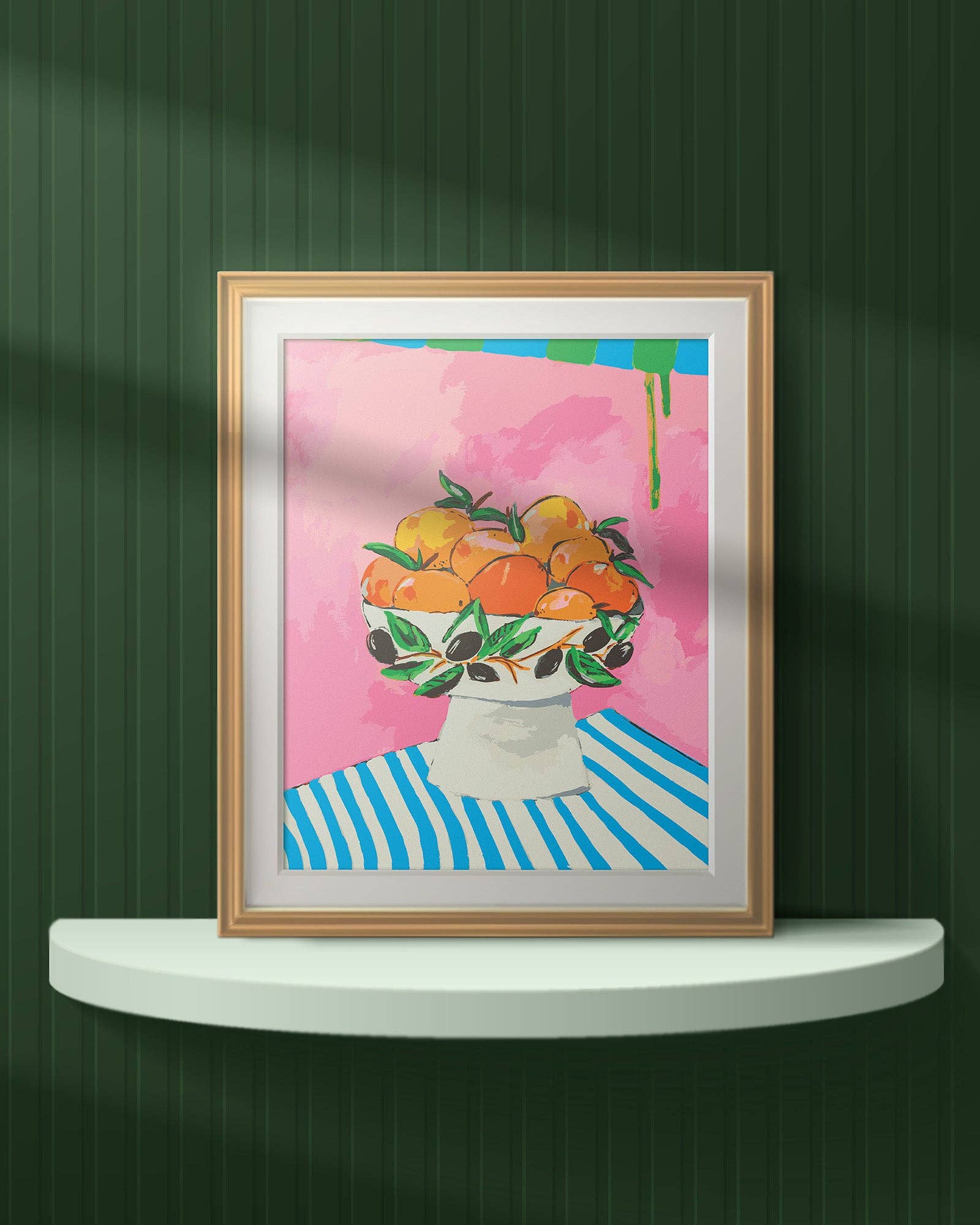 Framed artwork of a bowl of oranges on a striped tablecloth against a pink background.