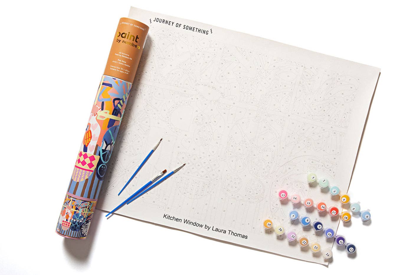 Roll of paint paper with paintbrushes and small bottles on a white background