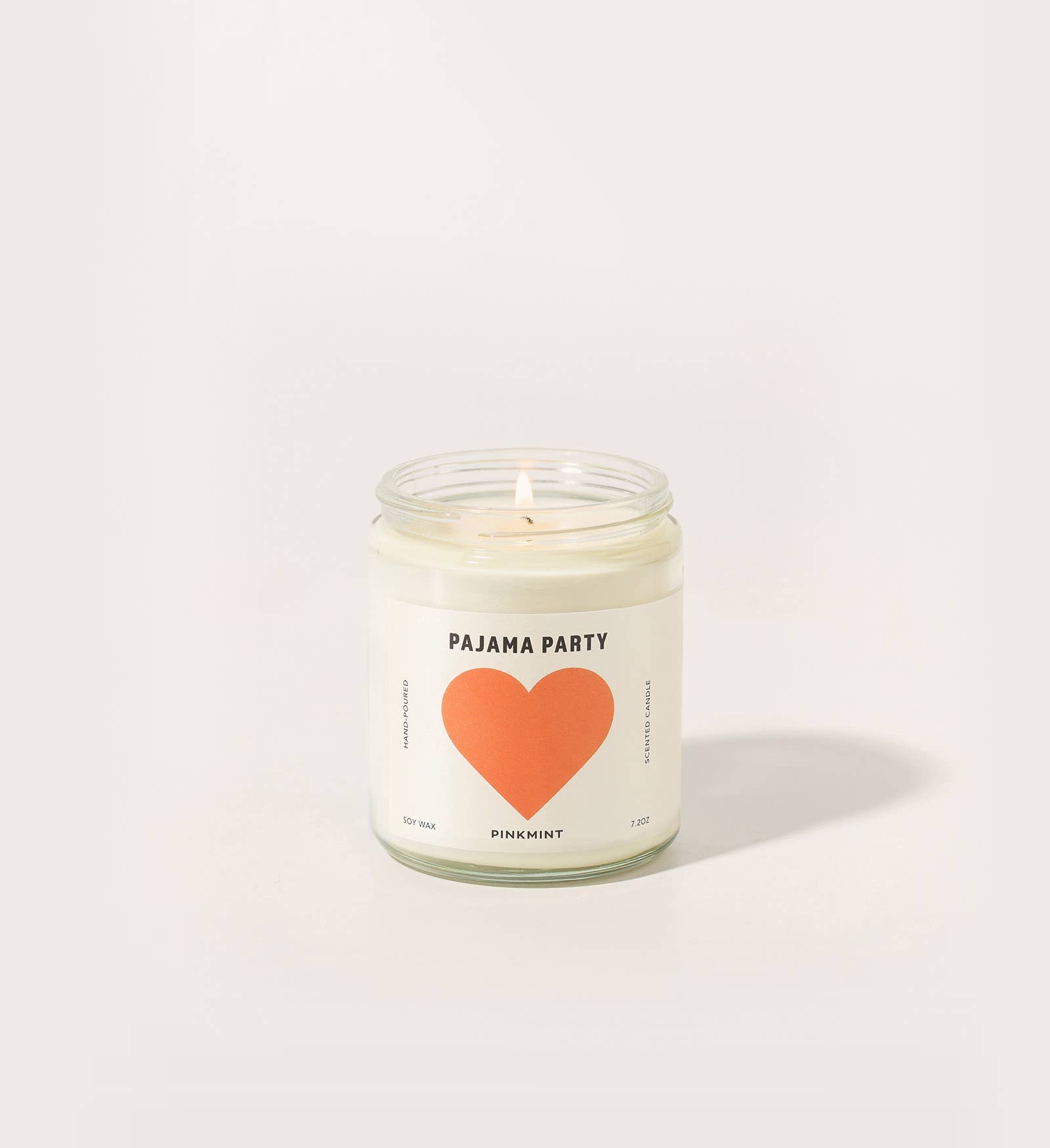 Candle with a heart design and text on a white background