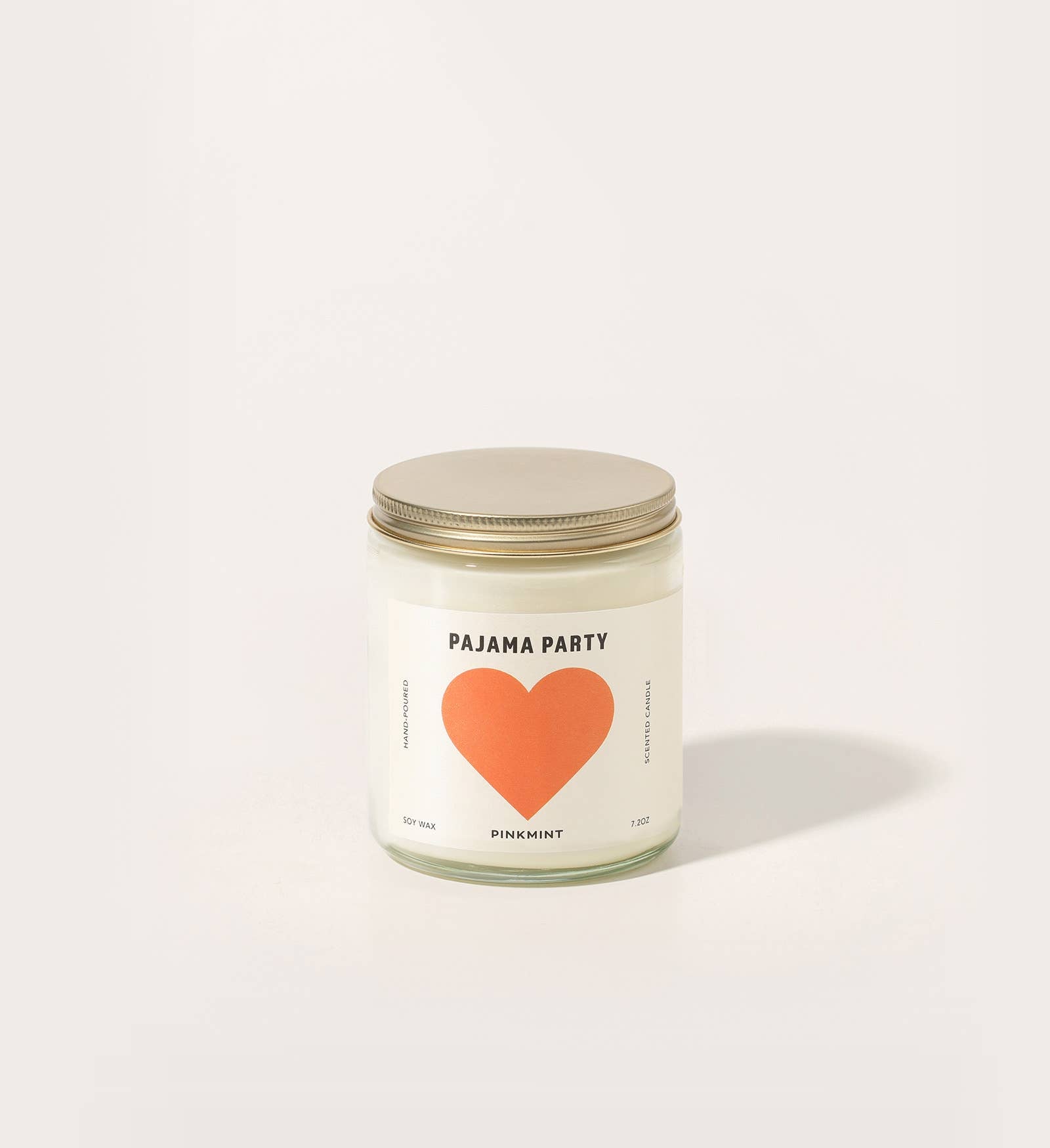 Candle jar with a heart design and text on a white background