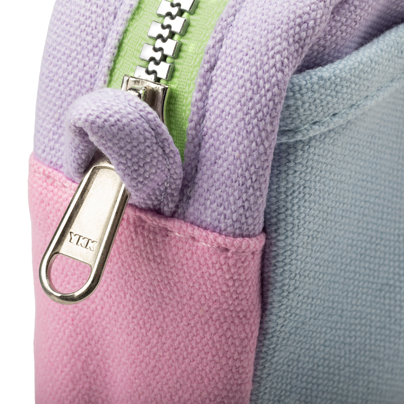 Close-up of a multicolored fabric with a zipper and YKK brand tag.
