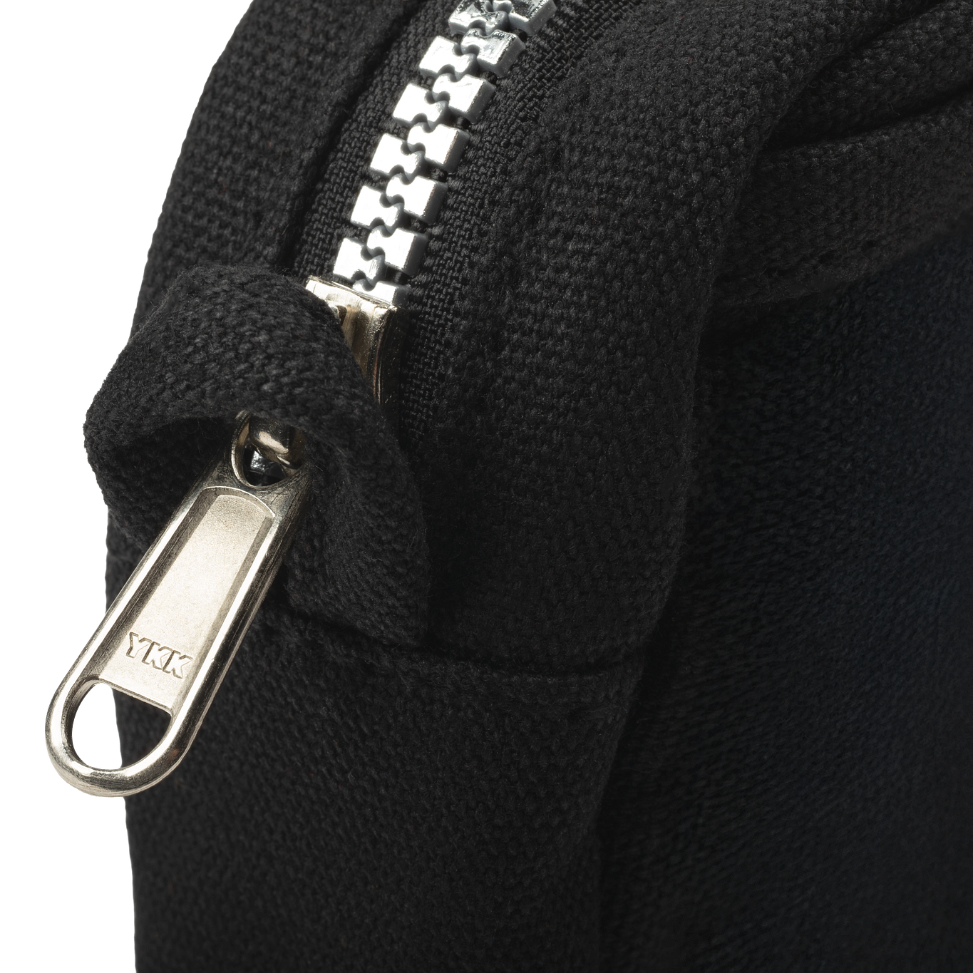 Close-up of a black fabric with a silver zipper and pull tab.
