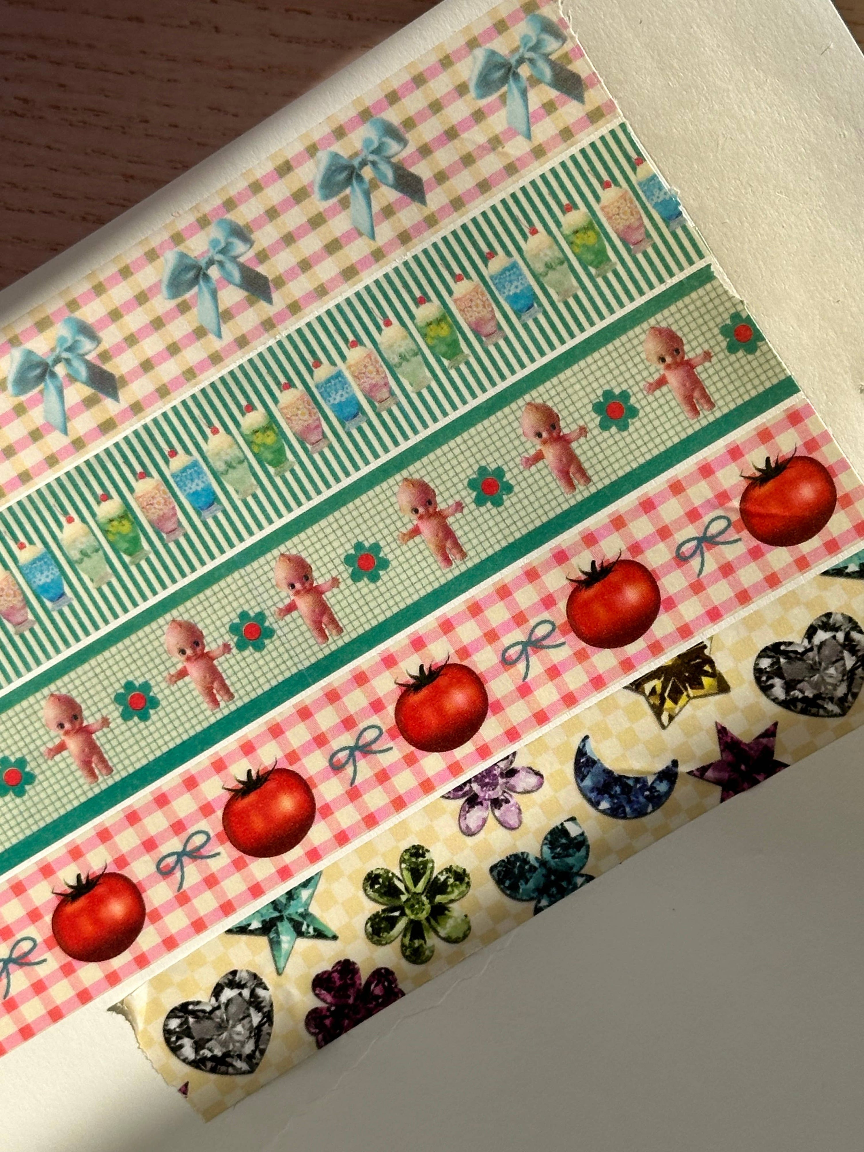 Collection of decorative washi tape strips with various patterns on a white background.