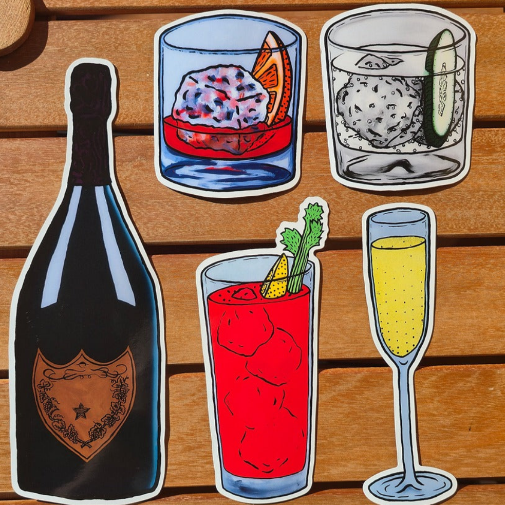 Set of six drink-themed magnets on a wooden surface
