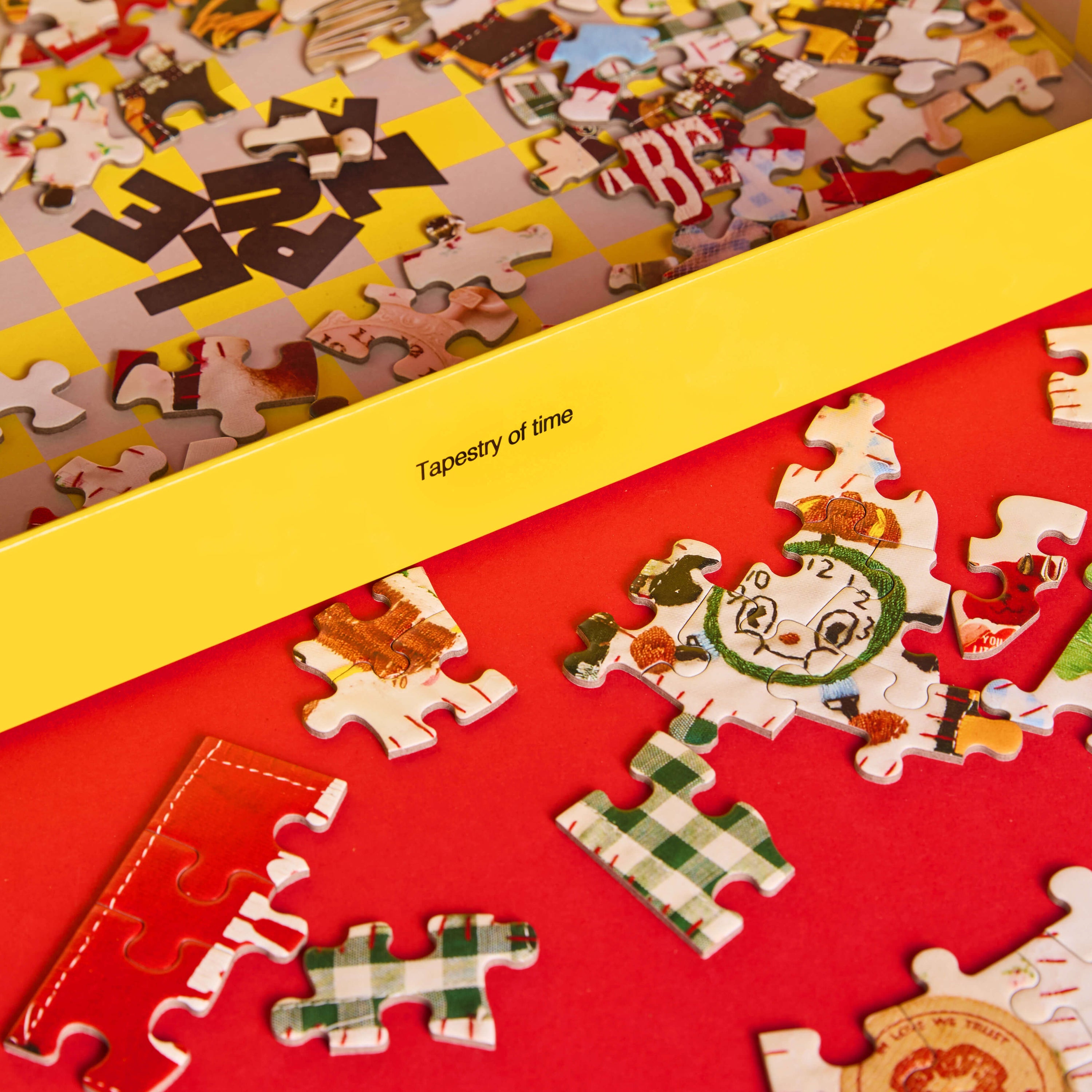 Jigsaw puzzle with partially completed pieces on a red baseboard, featuring the brand 'Tapestry of Time'.