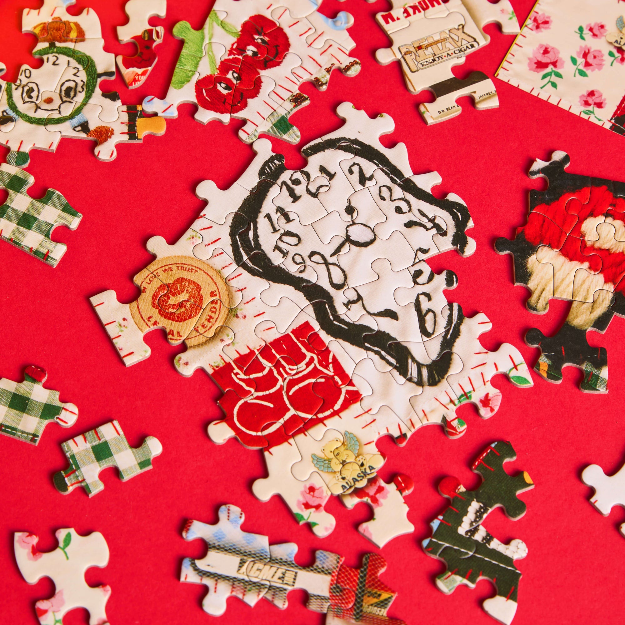 Jigsaw puzzle pieces on a red background with a focus on a completed section featuring a clock.