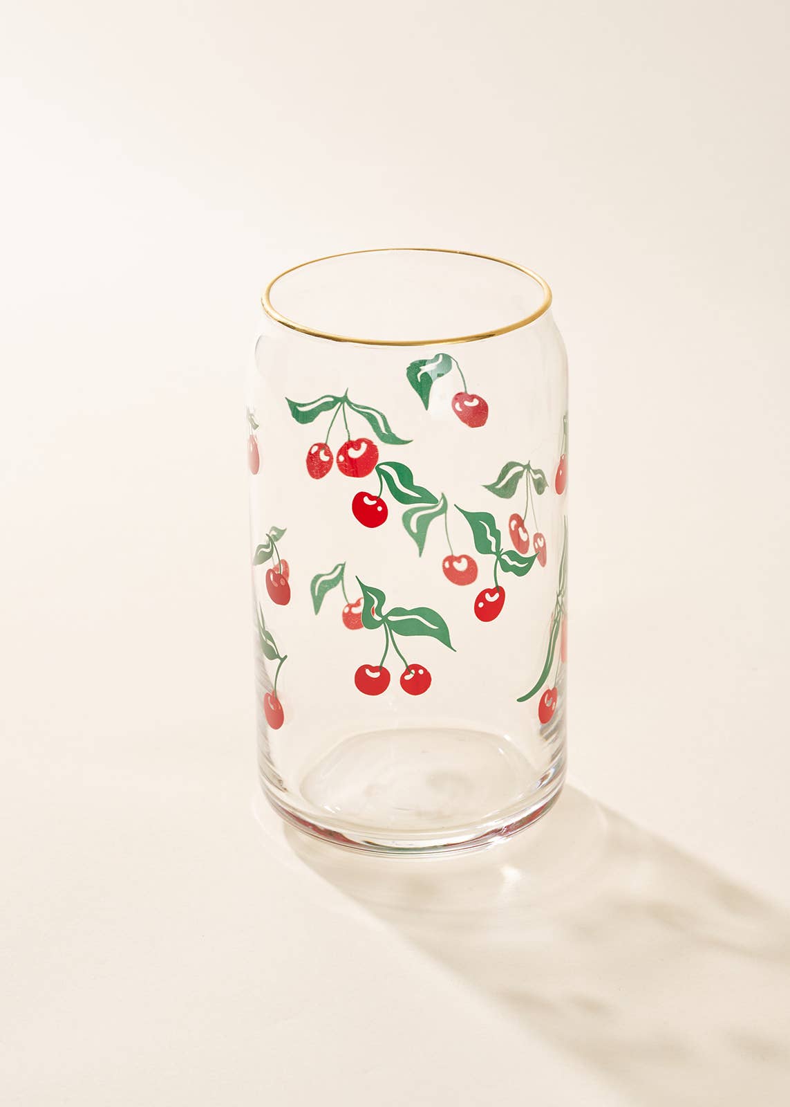 Clear glass tumbler with cherry design on a white background