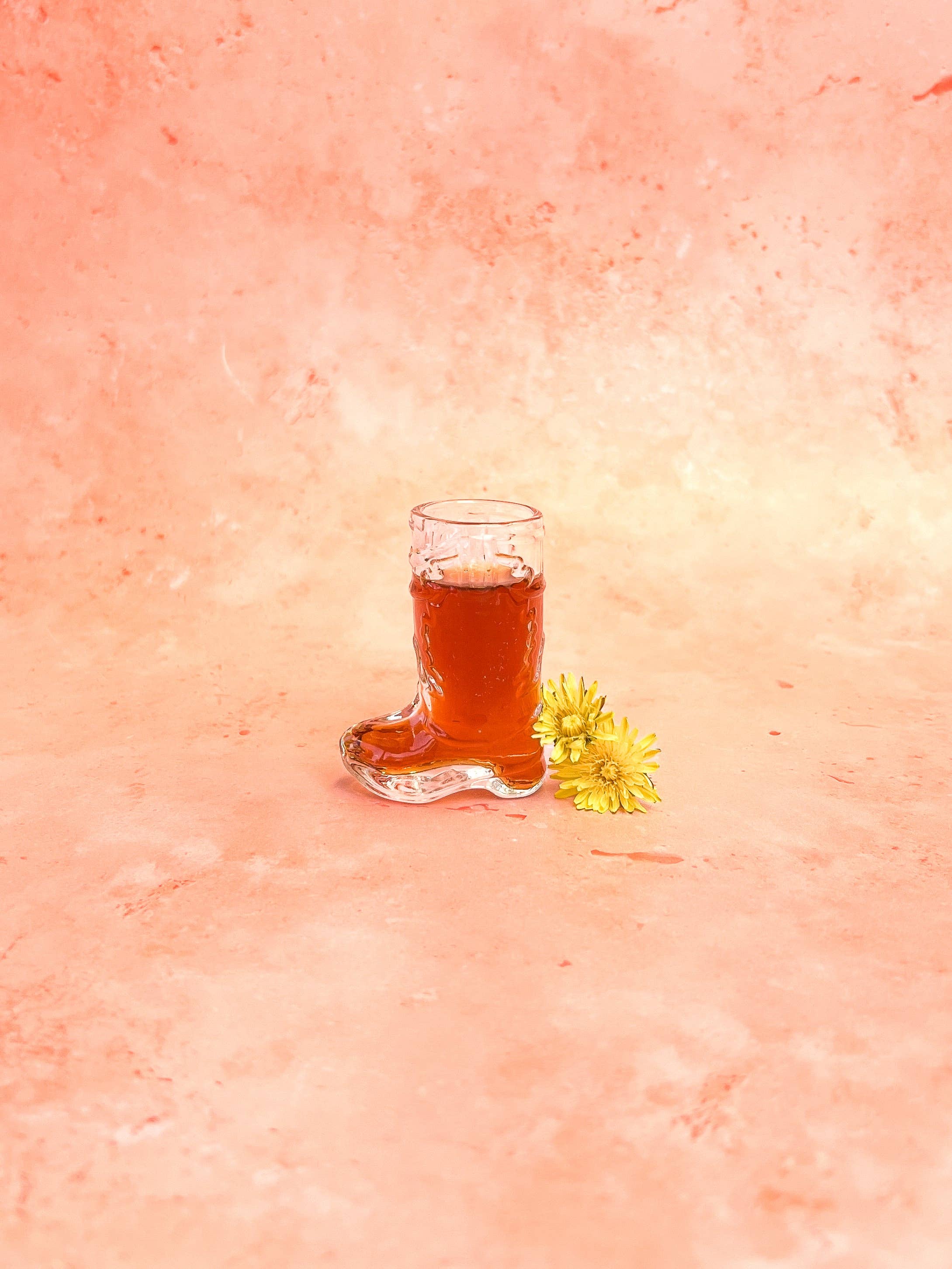 cowboy boot shot glass with pink background