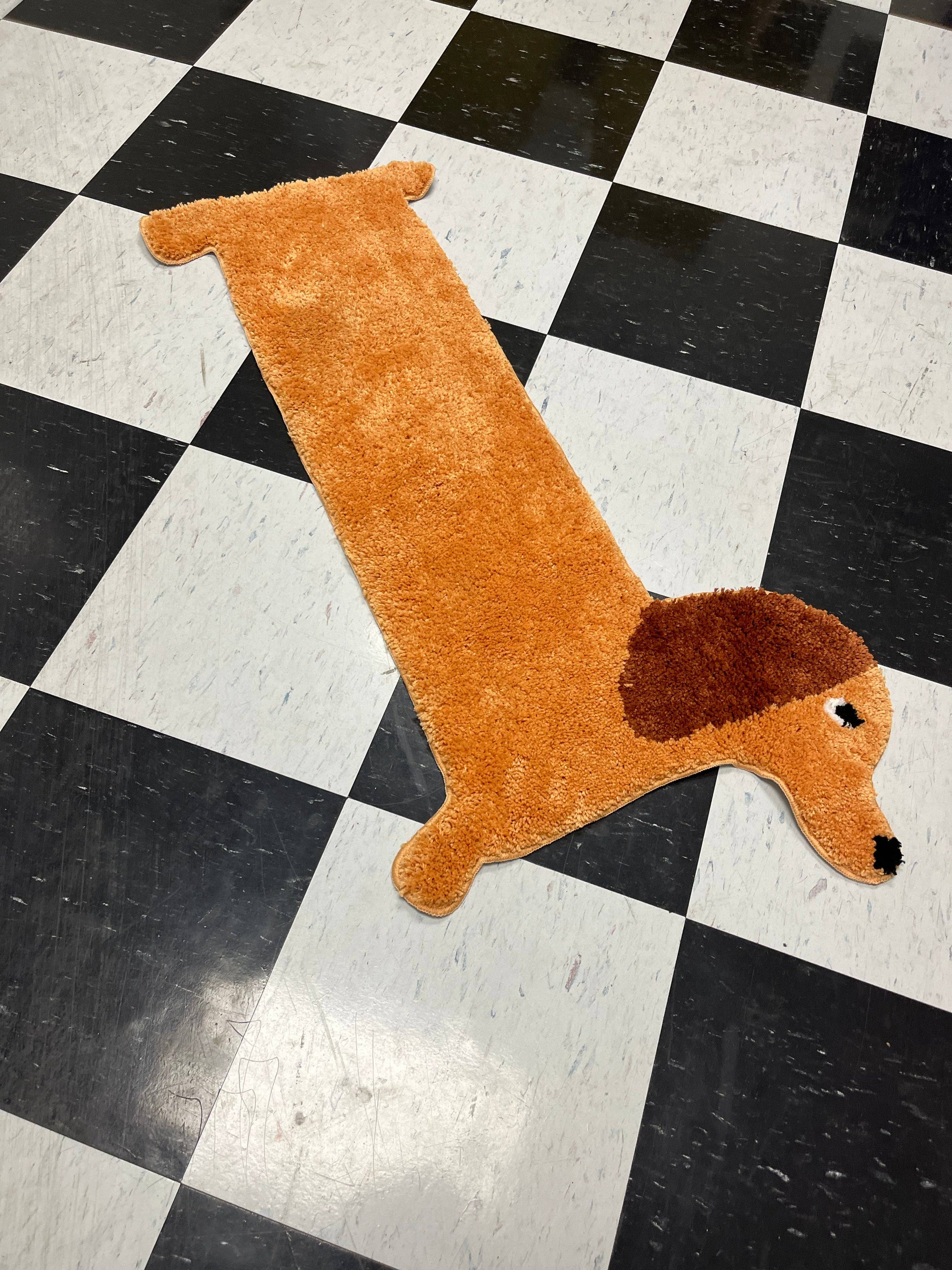 Dog-shaped brown rug on a black and white checkered floor