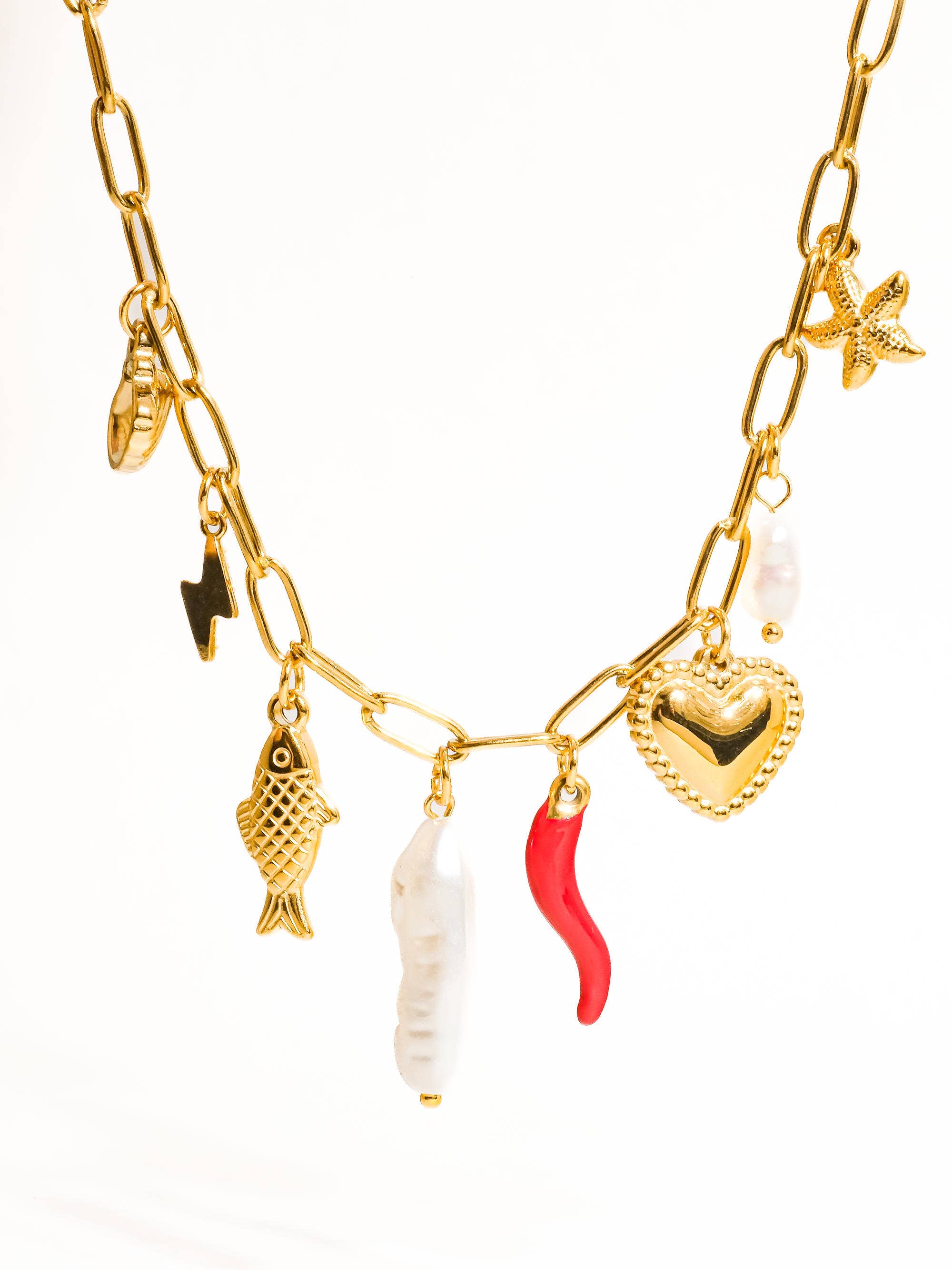 Gold necklace with various charms on a white background