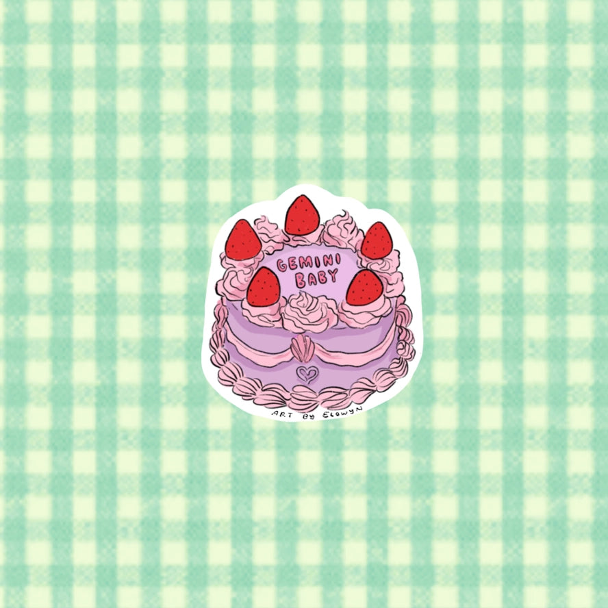 Sticker with cake design and 'Gemini Baby' text on a green and white checkered background