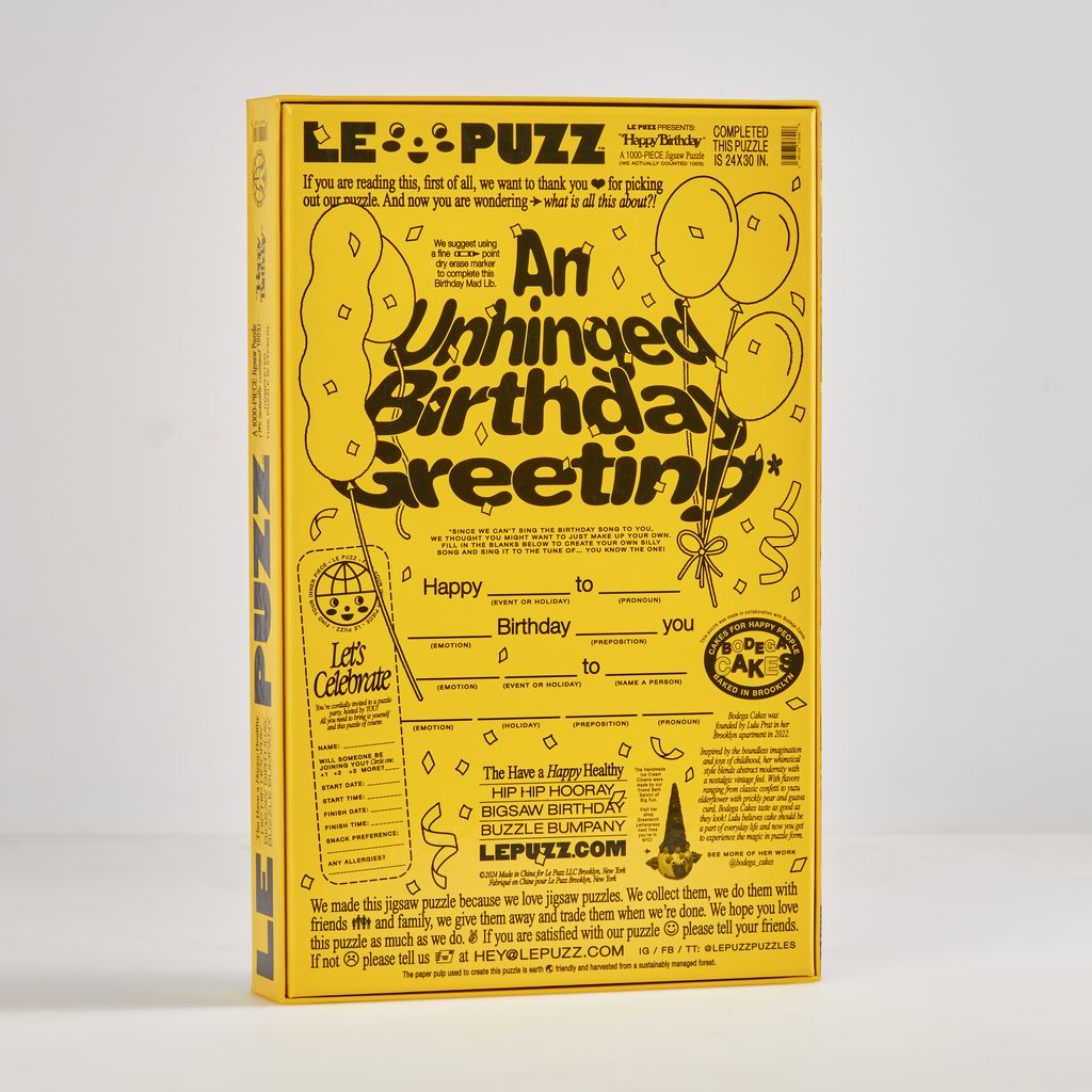 Yellow and black puzzle box with birthday greeting text on a white background