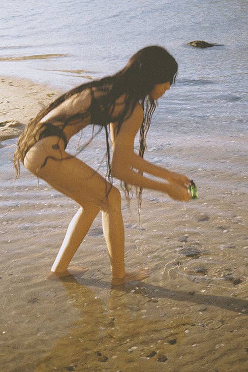 Woman playing with water on a beach