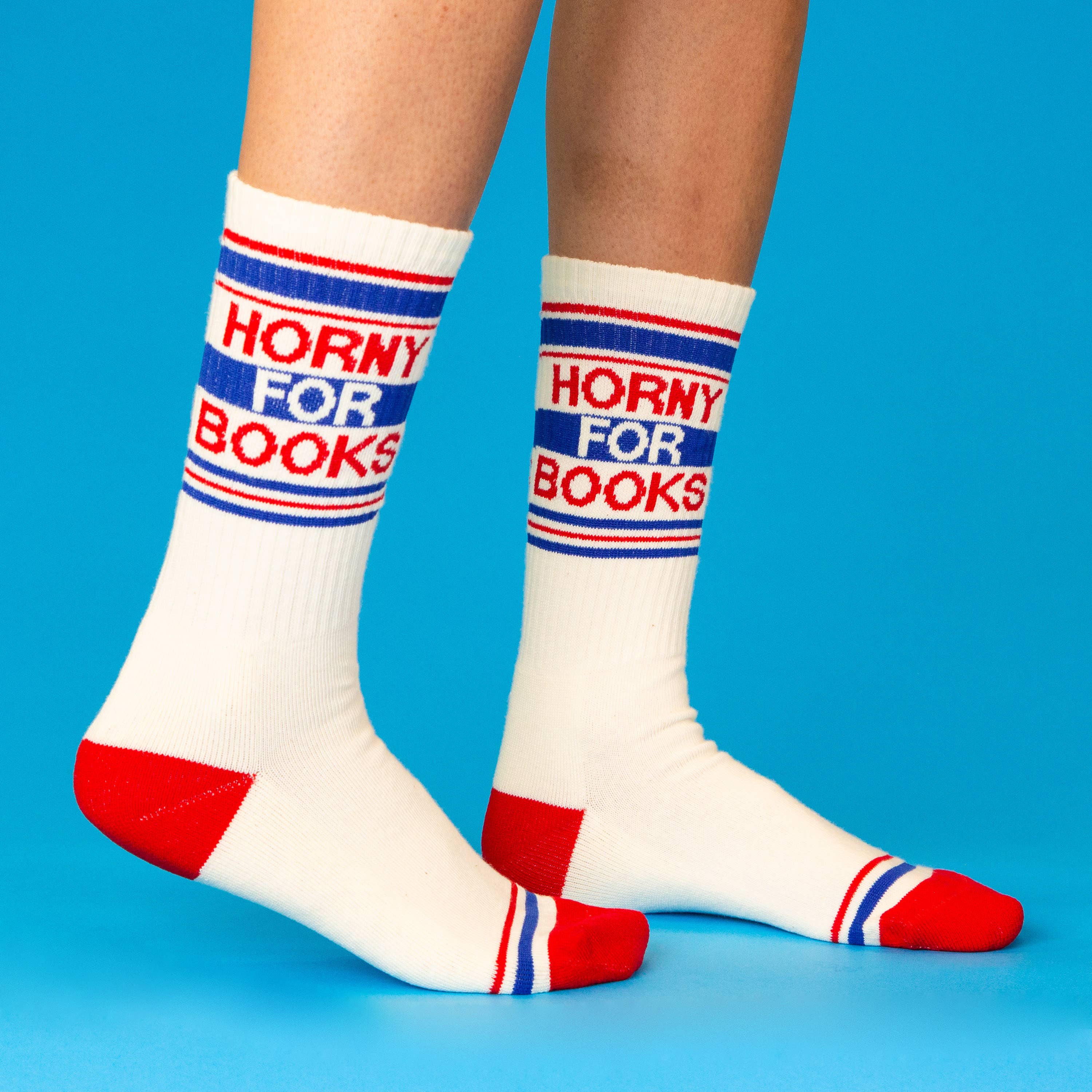 White socks with ' Horny for books' text on a blue background