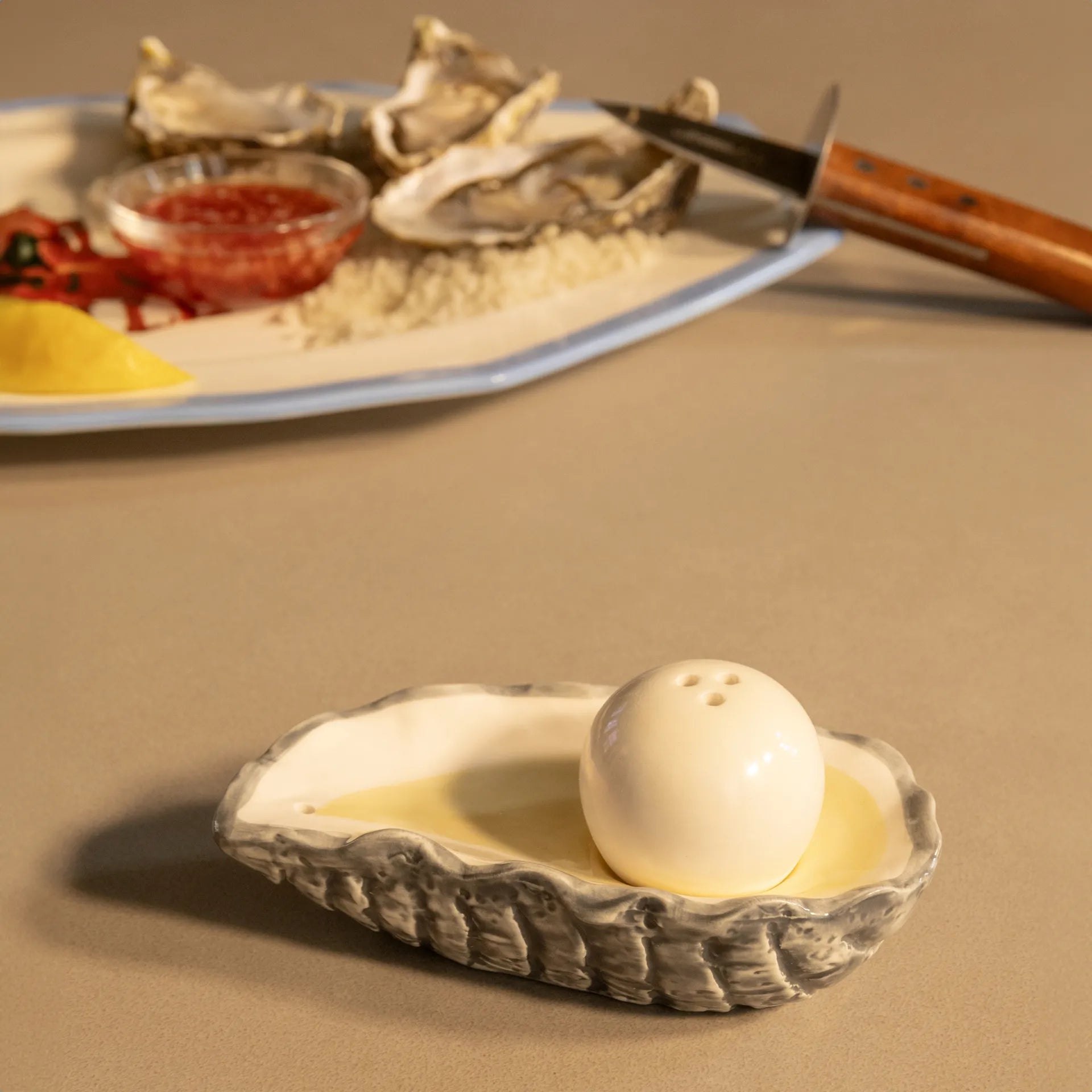 oyster salt and pepper shakers by klevering with oysters in the background