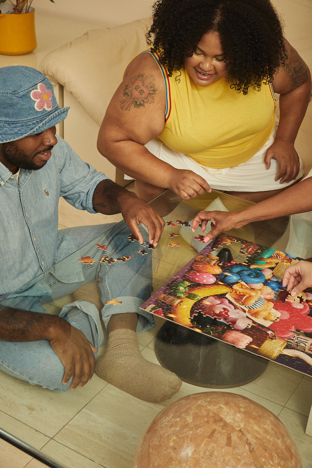 Two people working on a puzzle together in a casual setting.